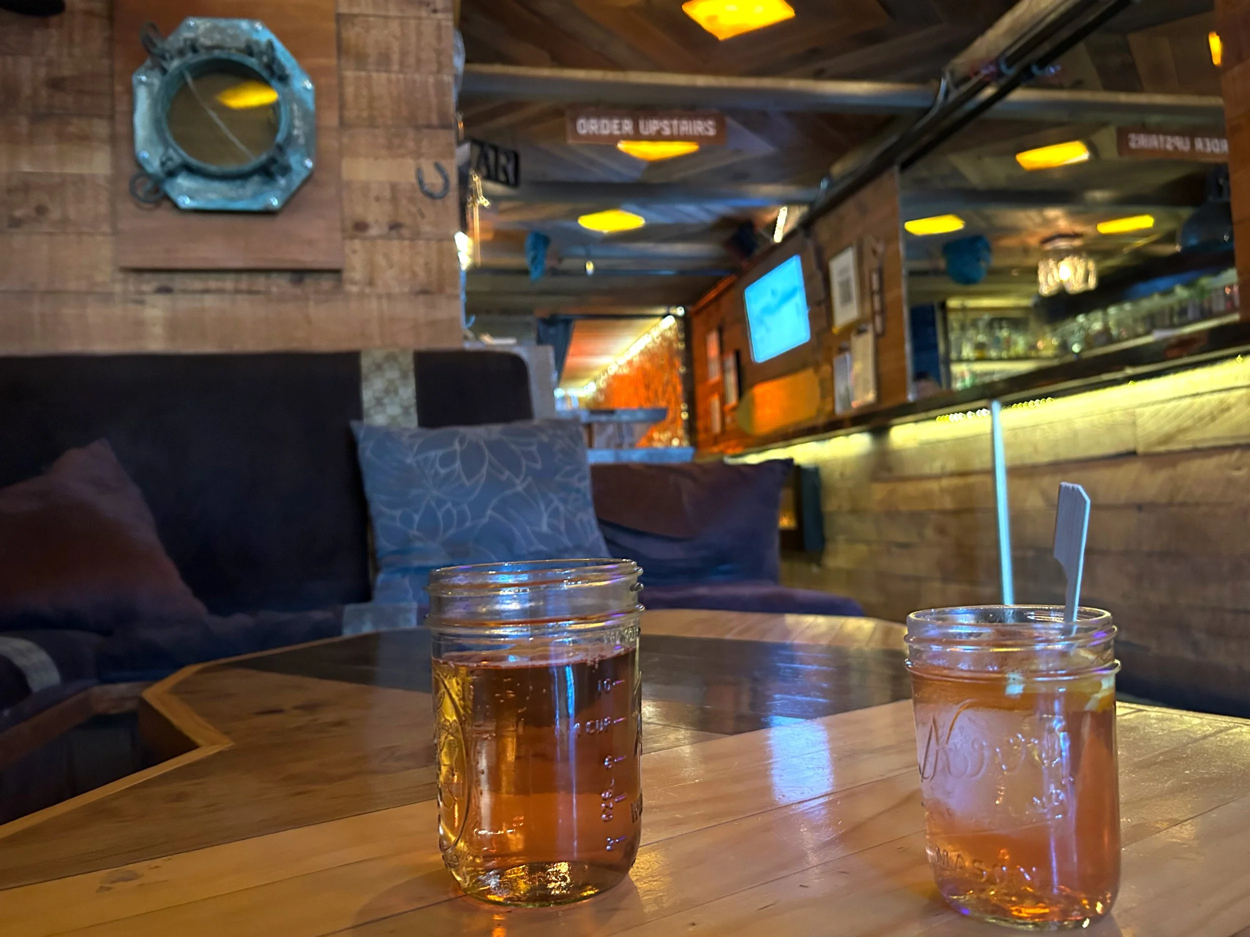 Mason jar cocktails on wood table at Velvet Lounge