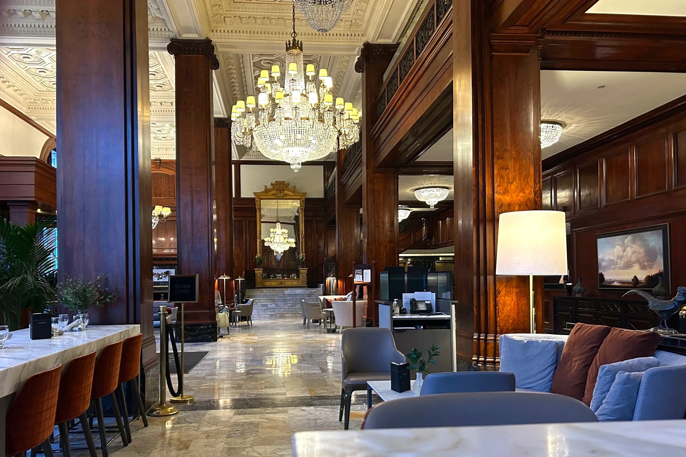 Chandelier hangs in elegant hotel lobby