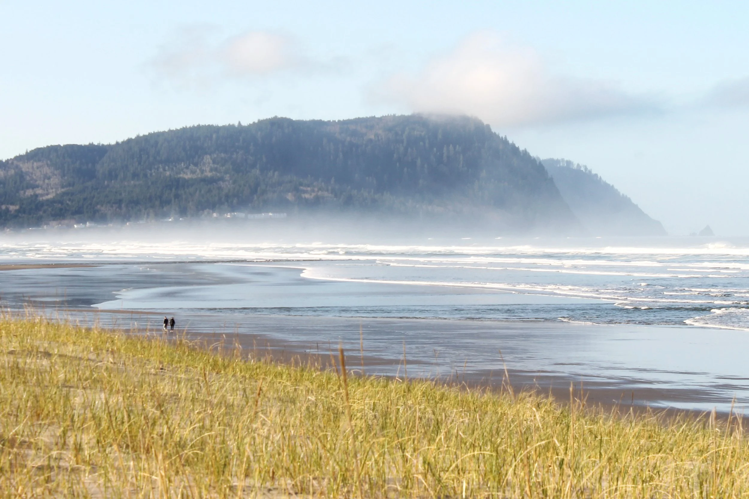 Two people walk on Gearhart Beach