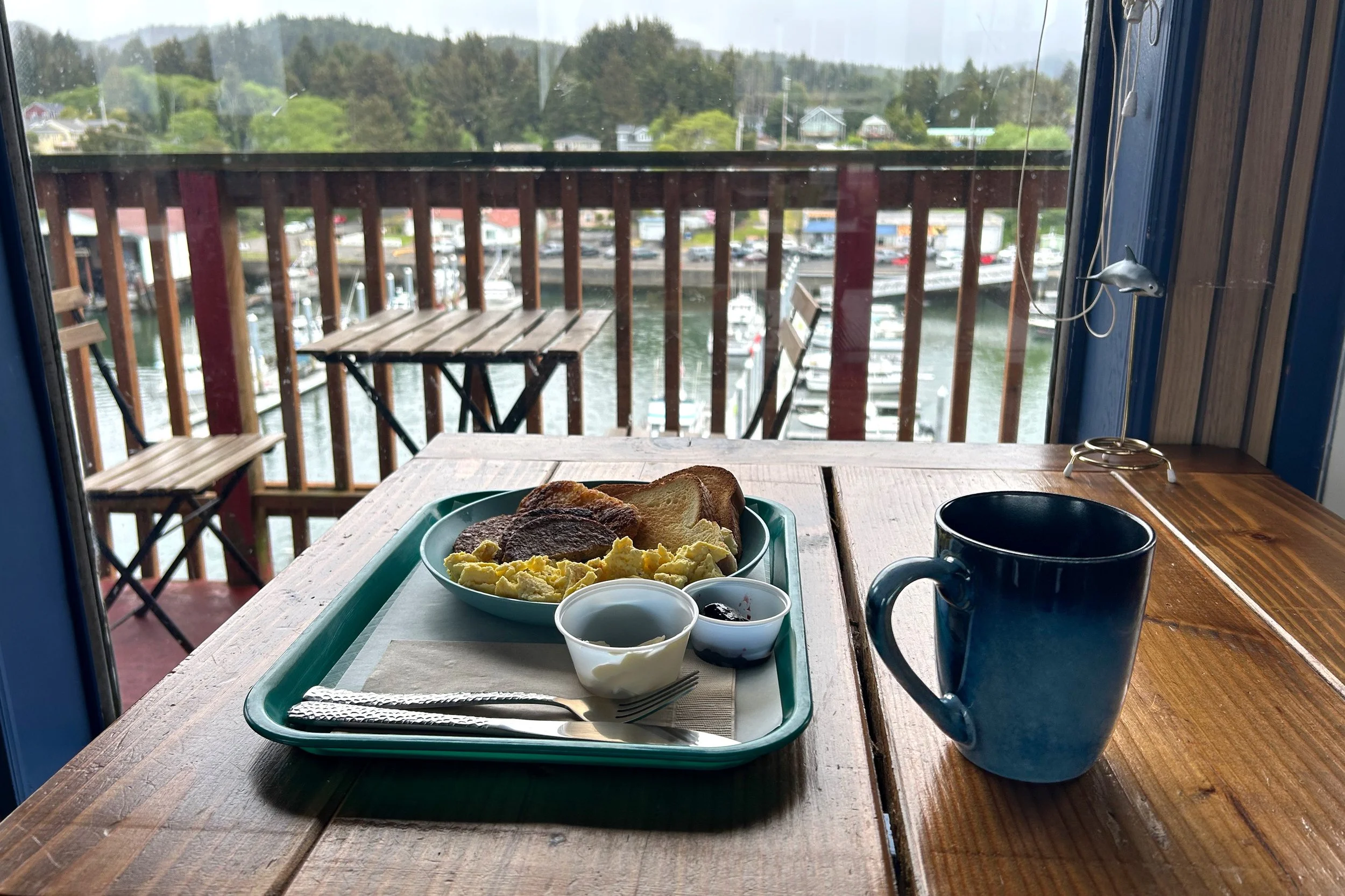 Breakfast at cafe table with harbor view