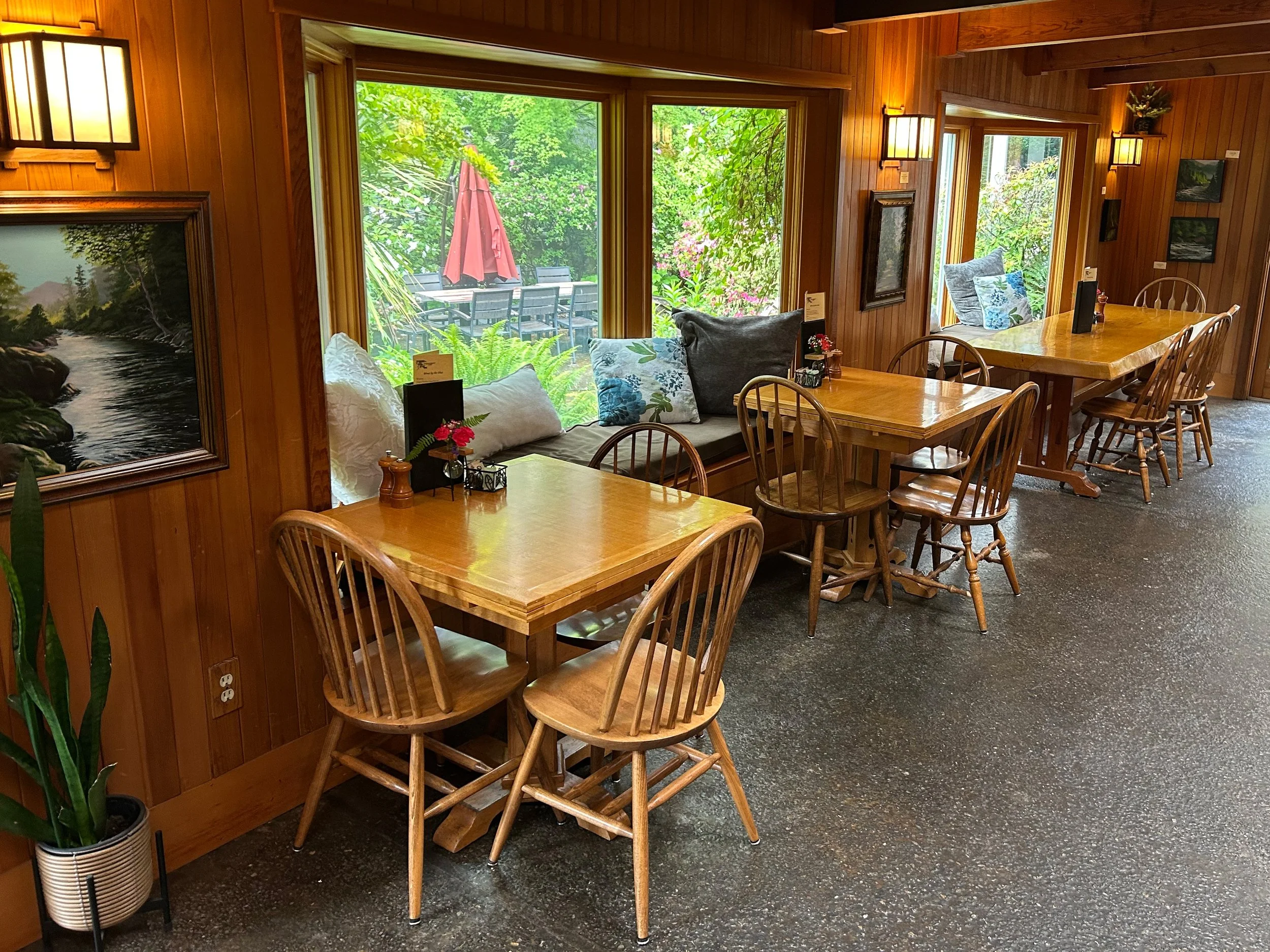 Tables in Steamboat Inn restaurant by windows with forest view