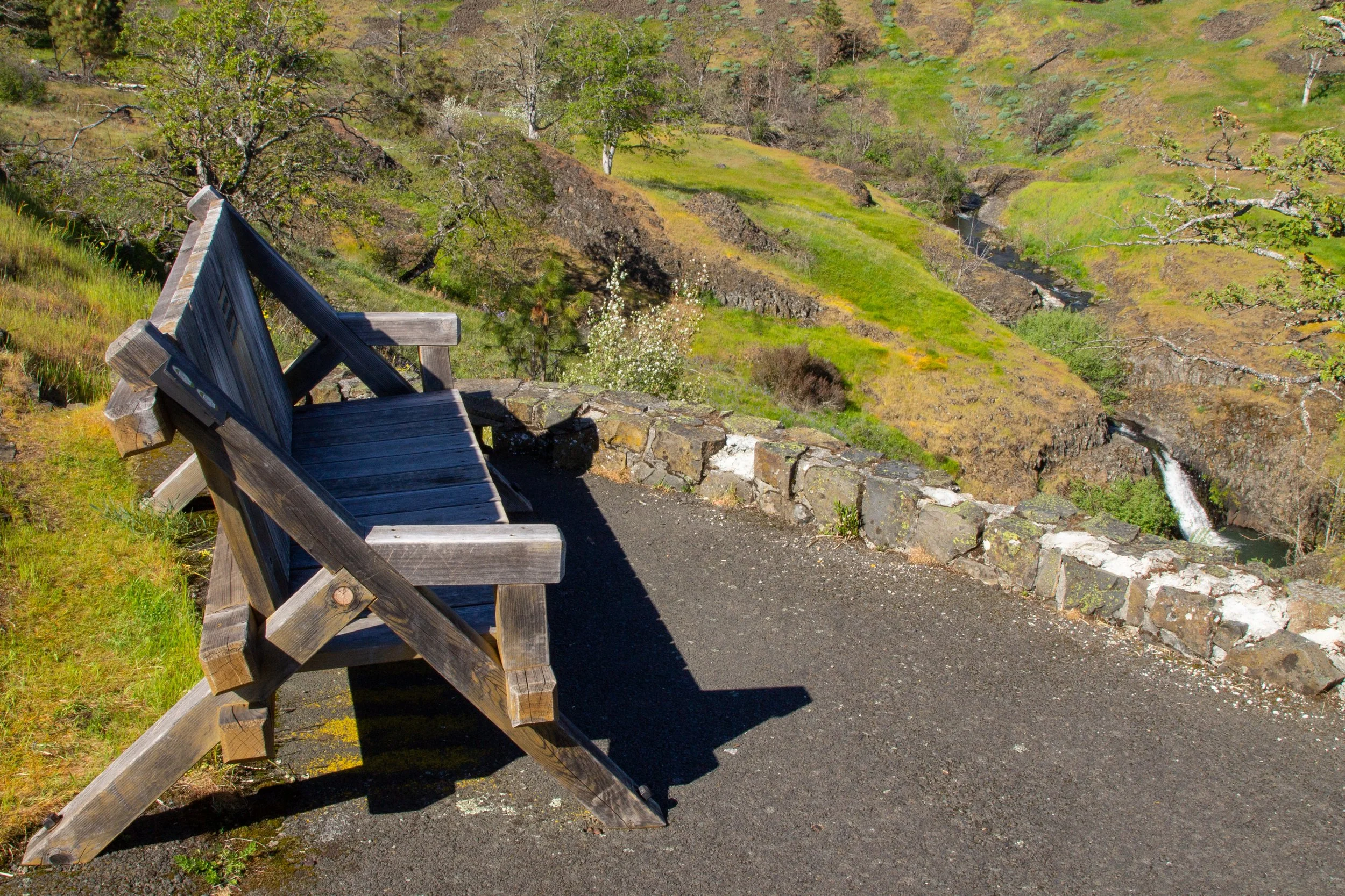Bench at overlook and small waterfall
