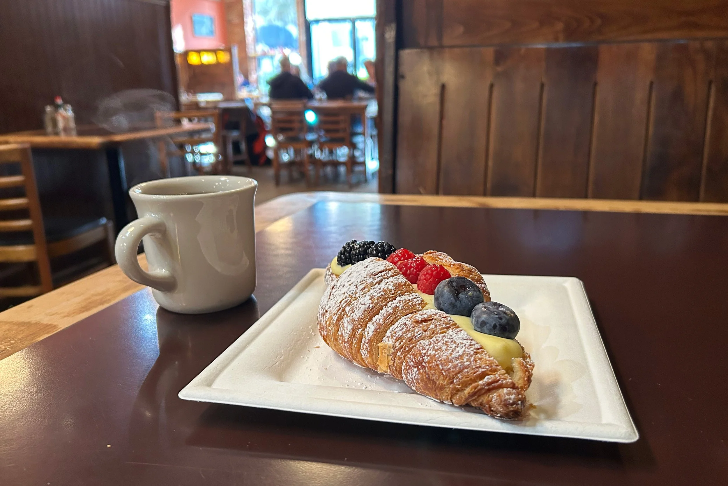 Pastry and coffee in cozy cafe
