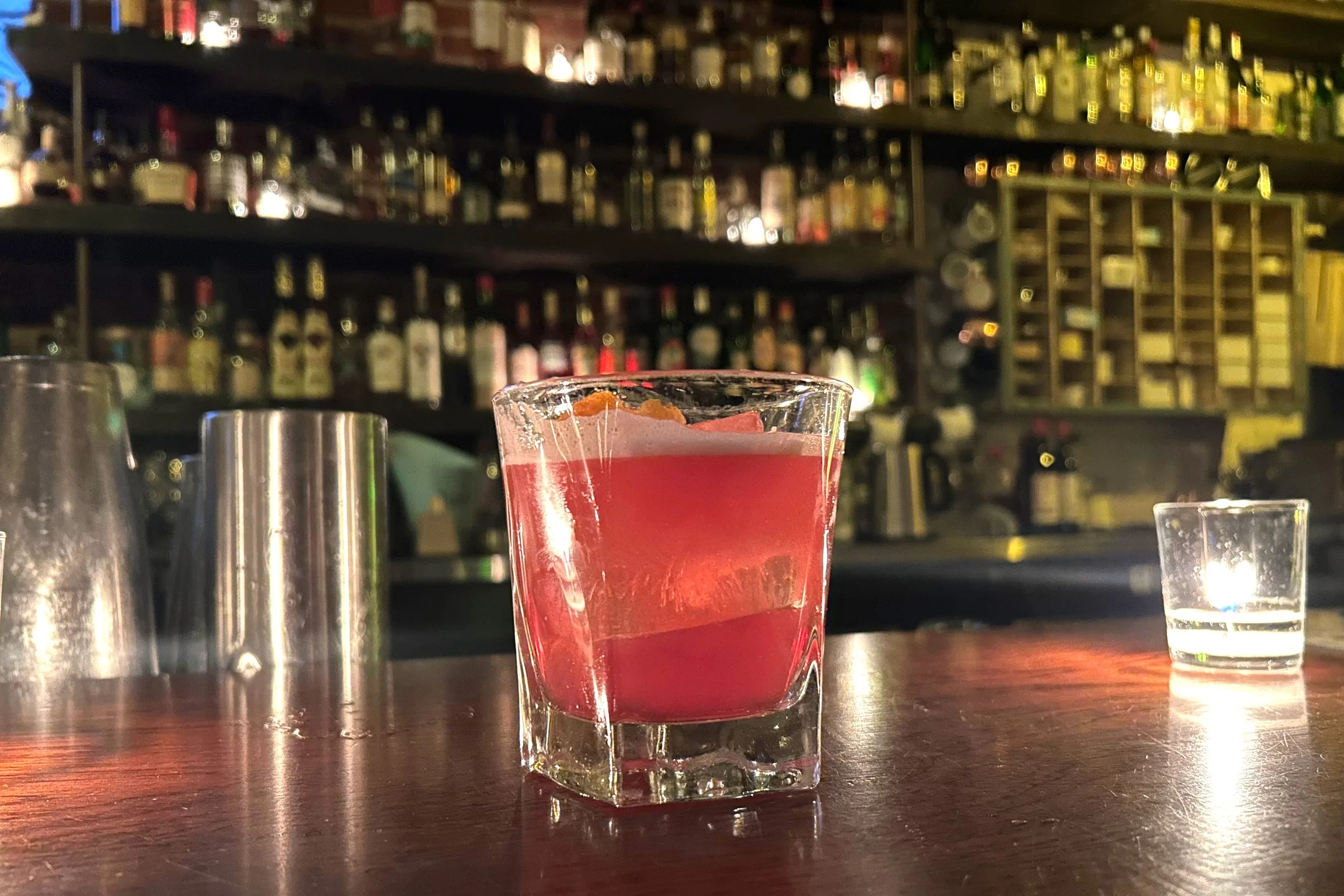 Bright pink cocktail on bar at San Simon
