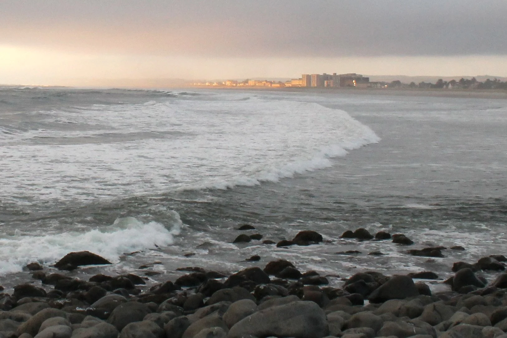 Seaside hotels in the distance across cove