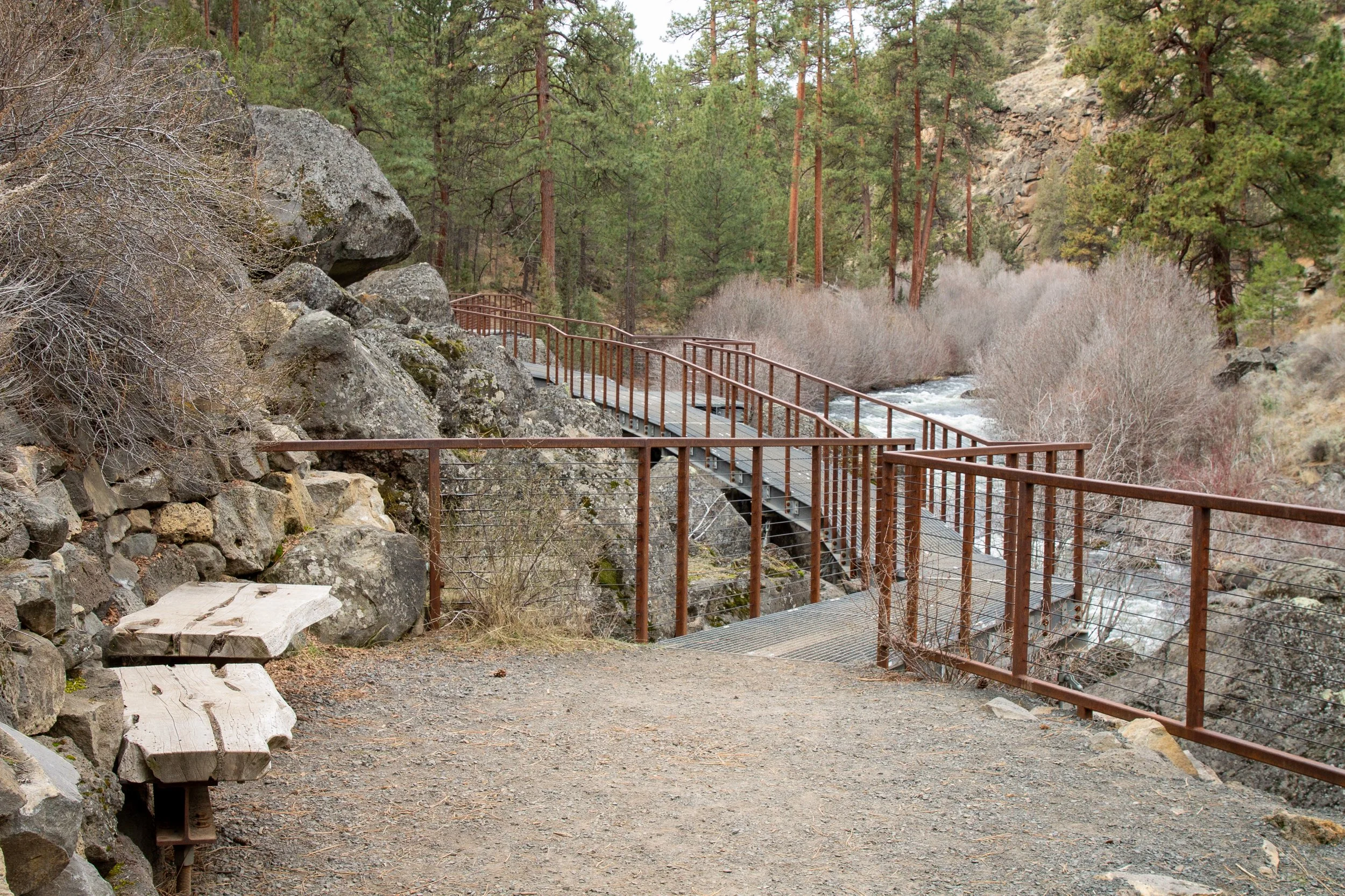 Metal walkway over boulder next to Deschutes River