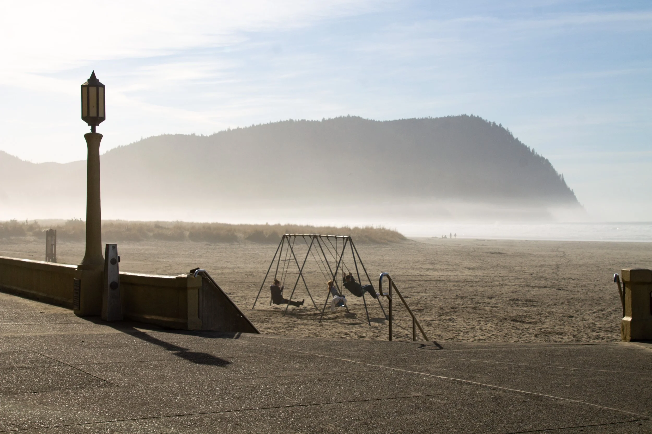 People on swings on Seaside Beach