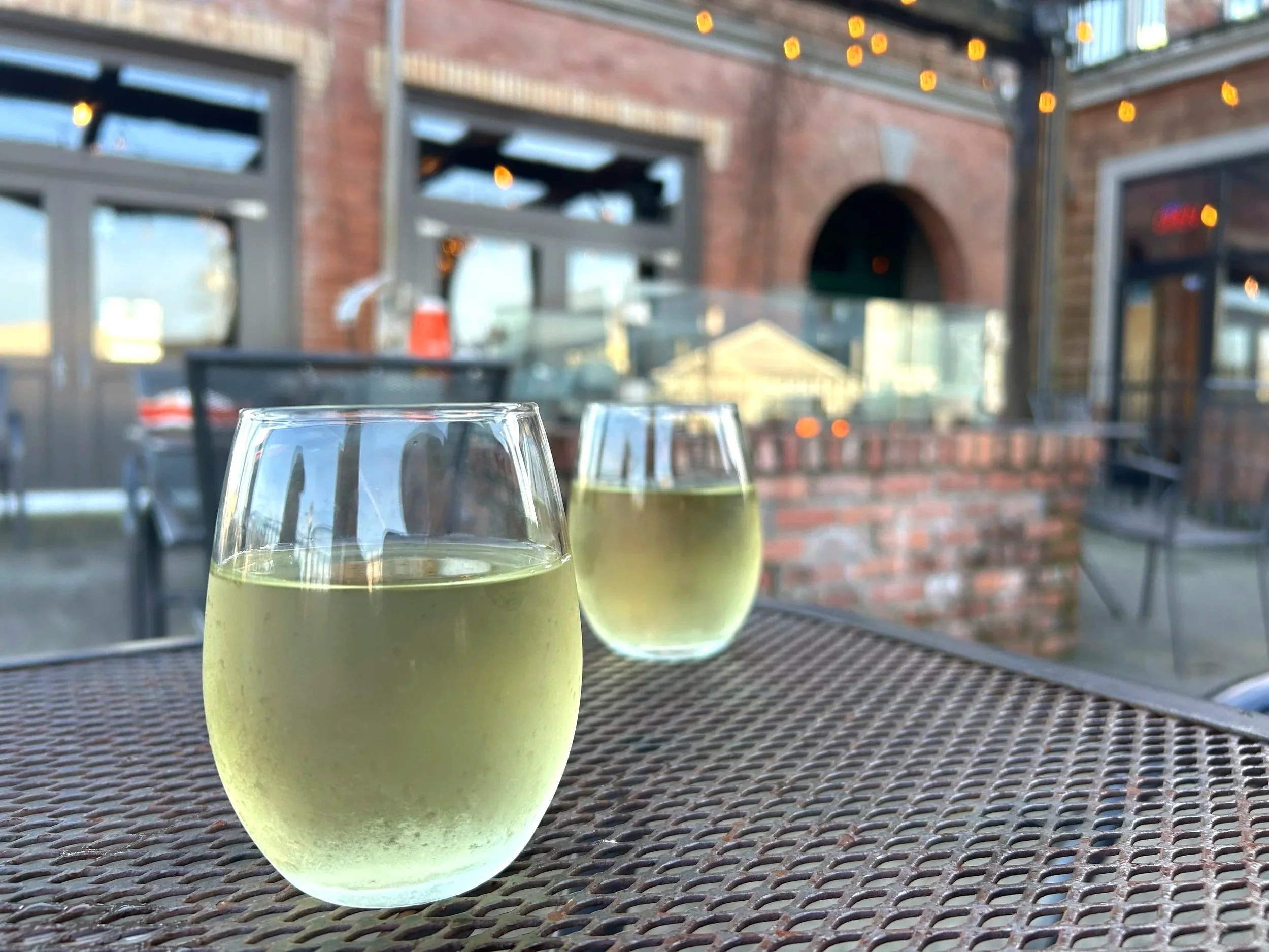 Glasses of wine on patio with fire pit