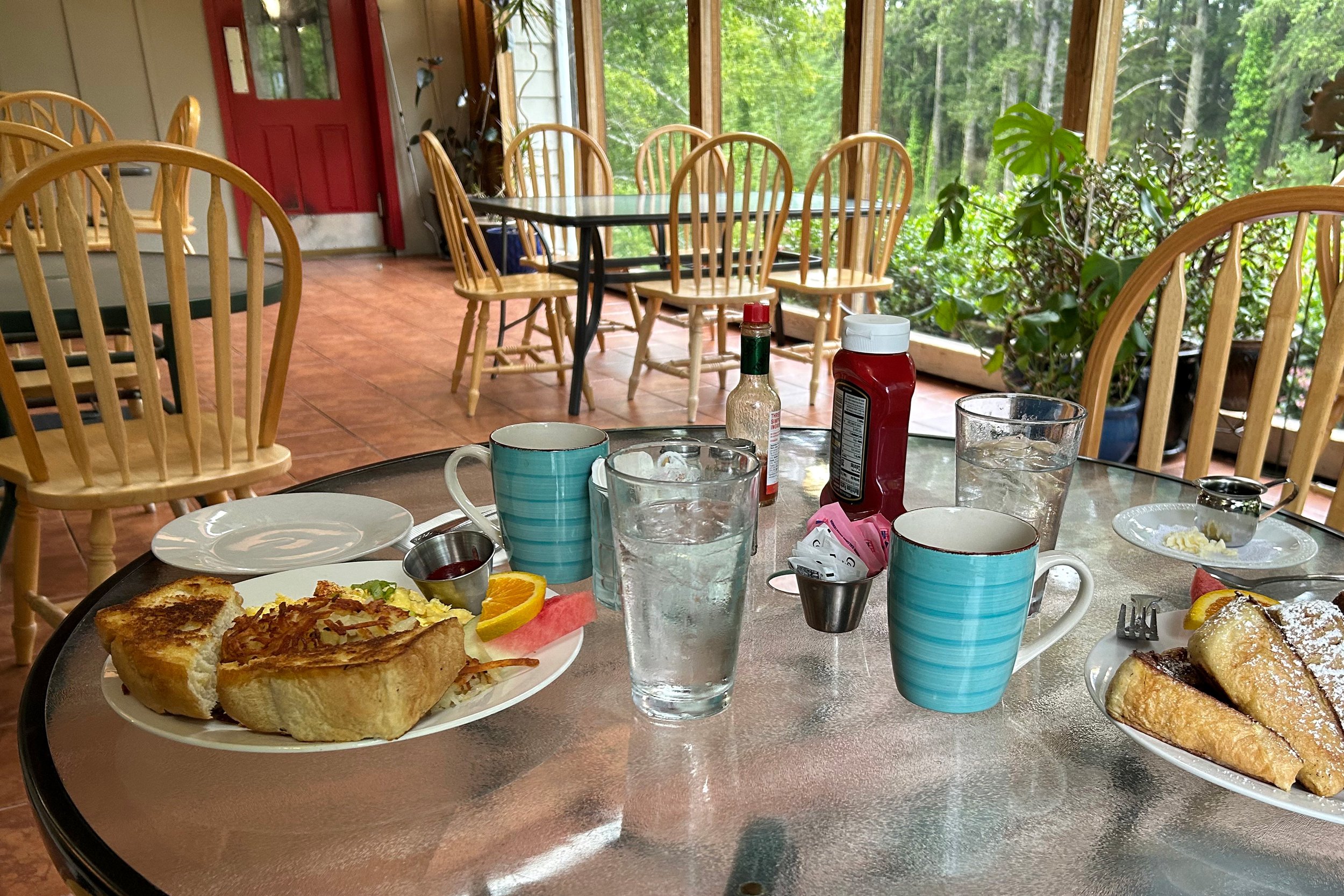Breakfast in restaurant with large windows overlooking greenery