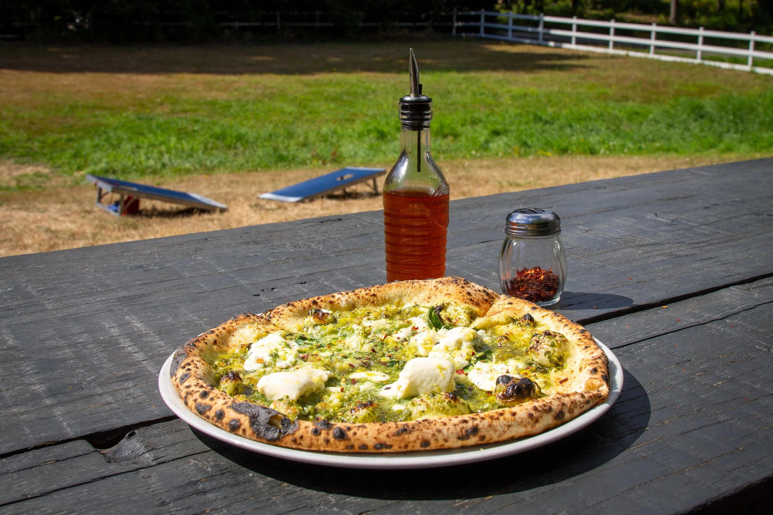 Pizza on outdoor picnic table