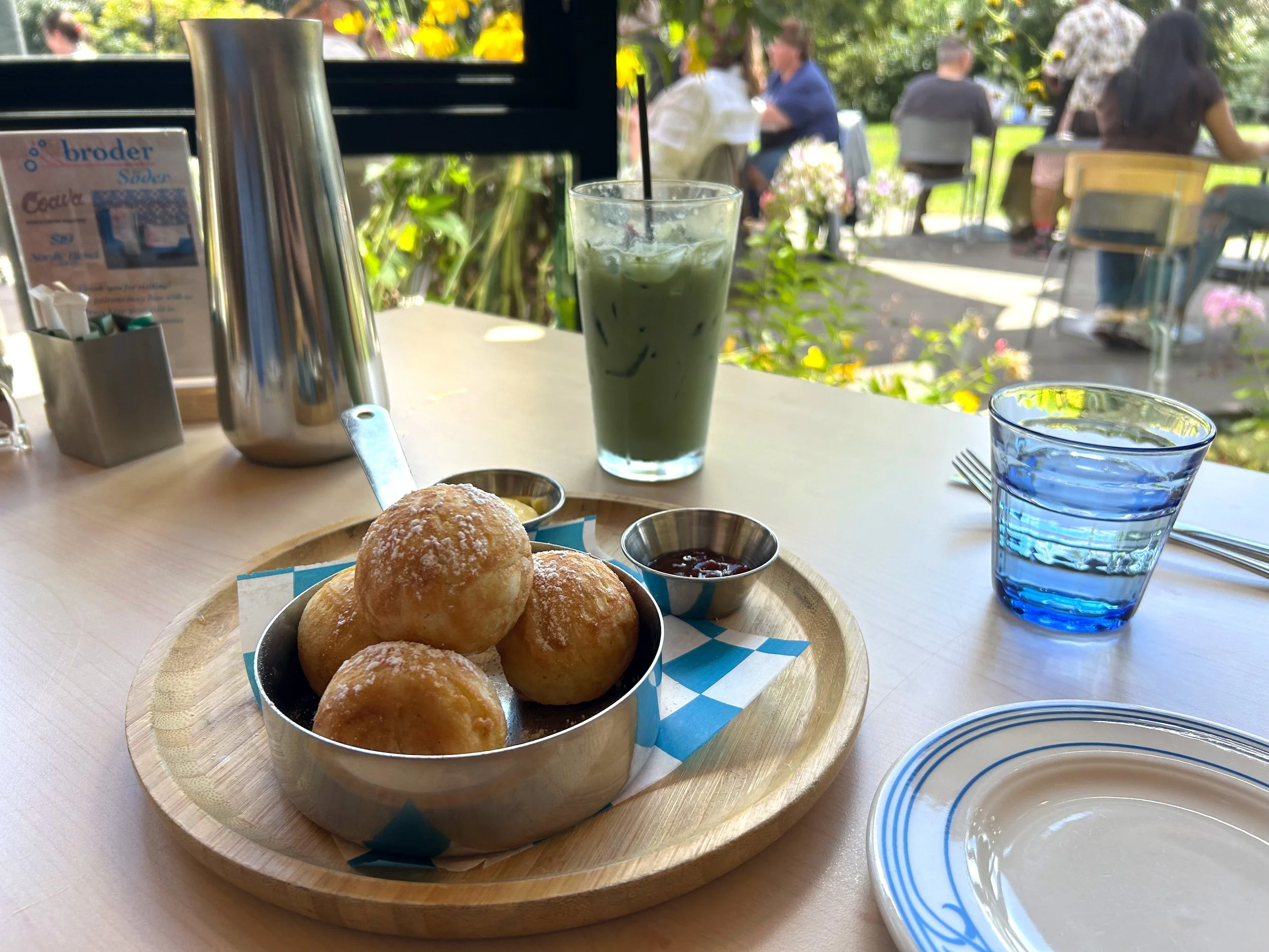 Pancake balls and iced matcha at restaurant with patio view