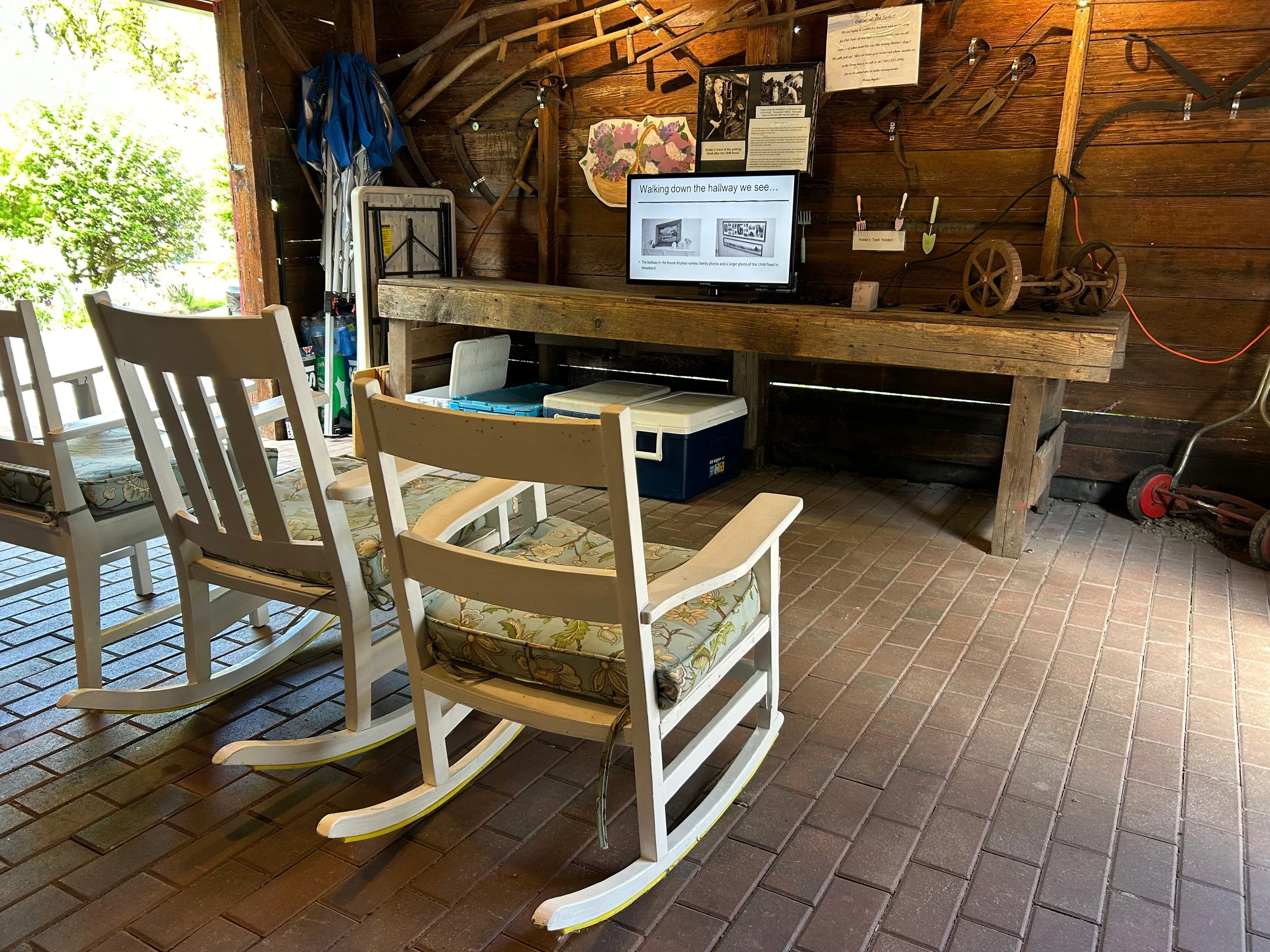 Rocking chairs in shed face TV with presentation