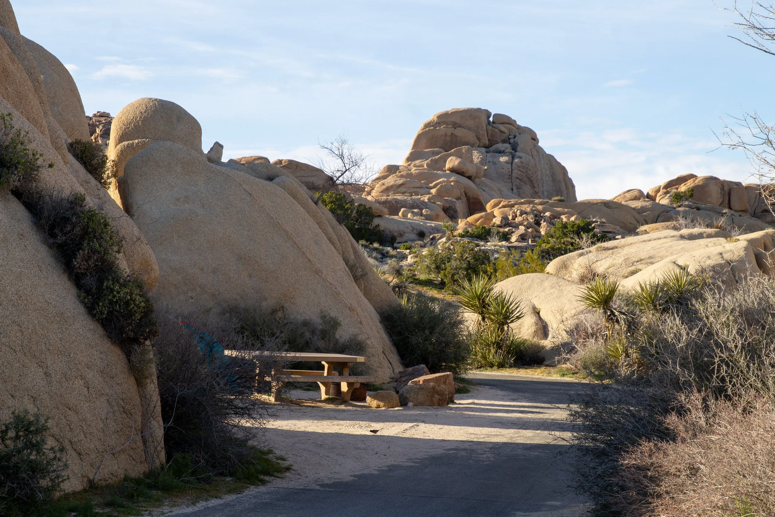 Picnic table by huge boulders