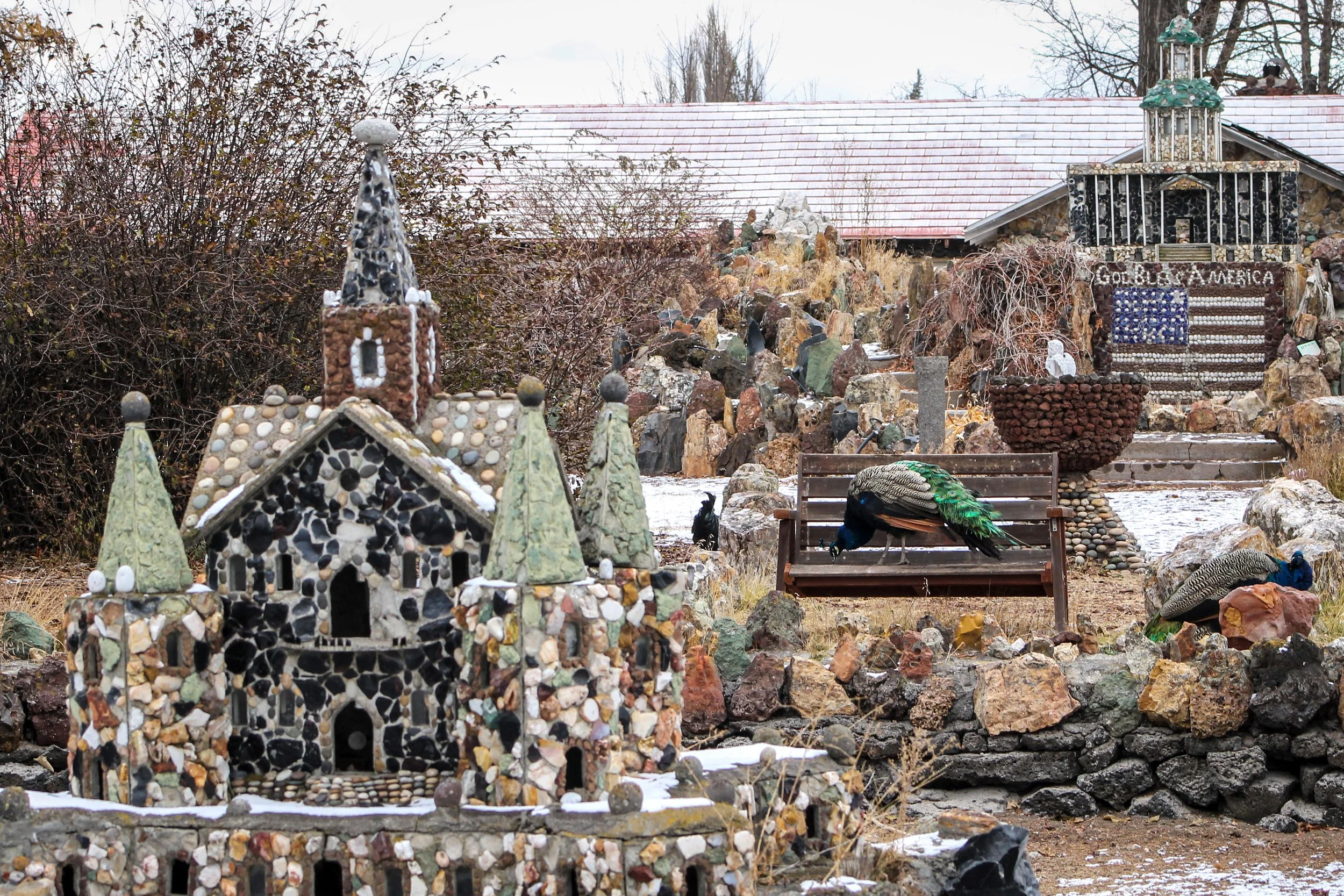 Peacock and rock sculptures at Petersen Rock Garden