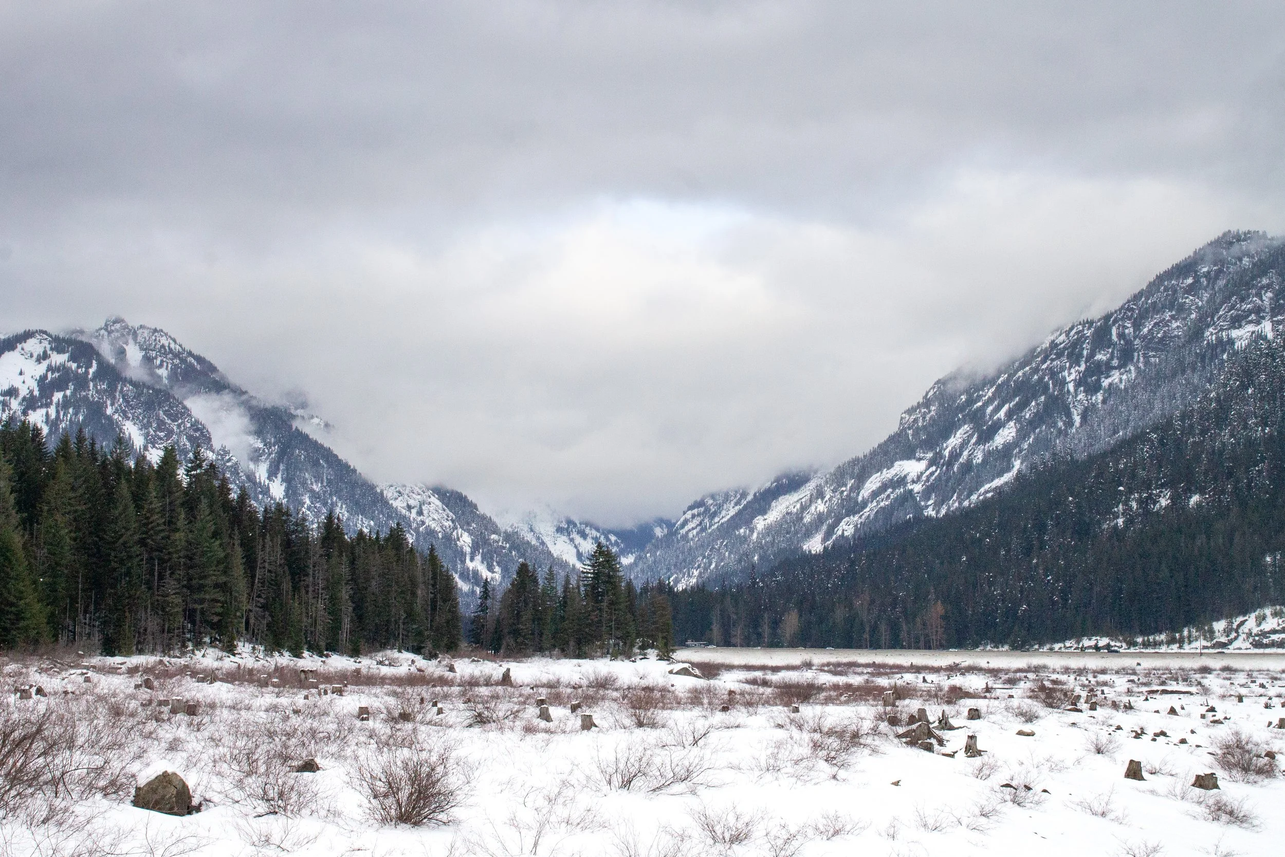 Mountains behind snowy field