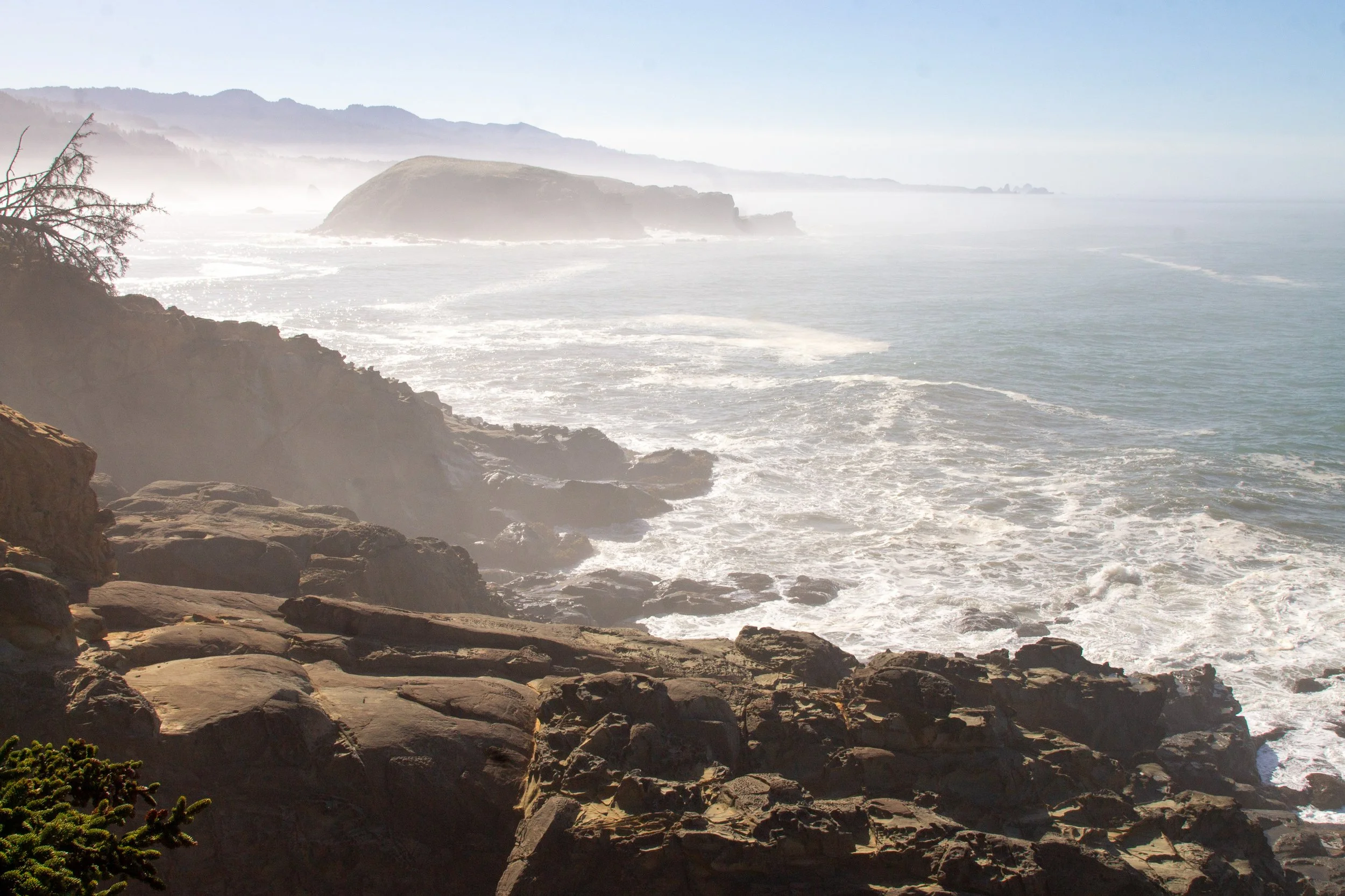 Island near rocky coast on foggy day