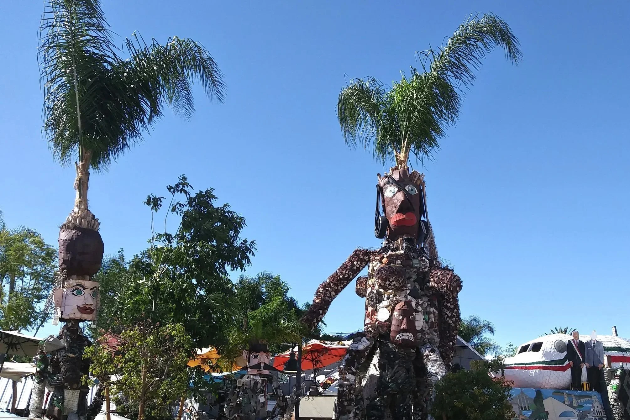 Folk art statues with palm tree headdresses