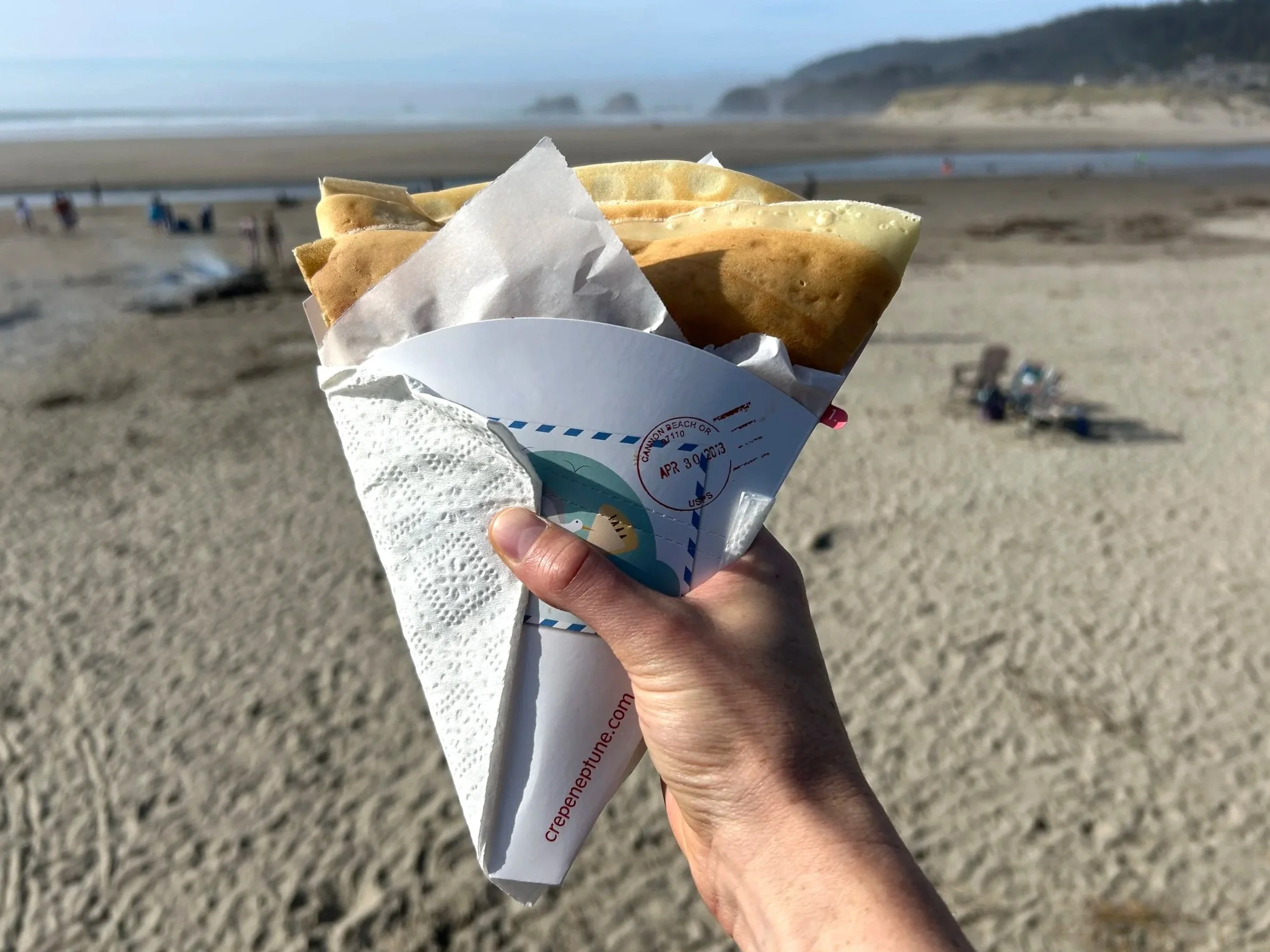Hand holding crepe on Cannon Beach