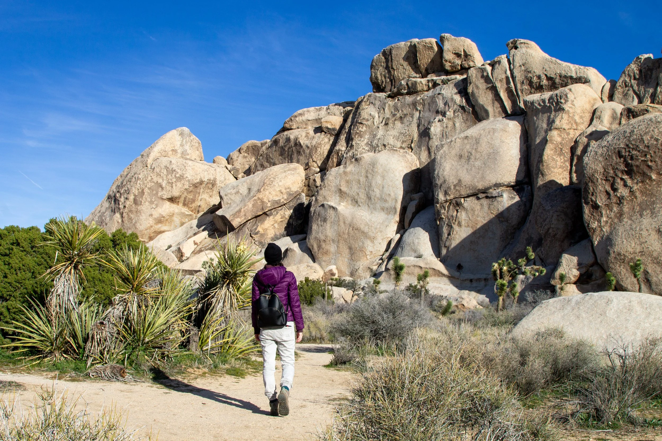 Woman in jacket on trail in Joshua Tree National Park