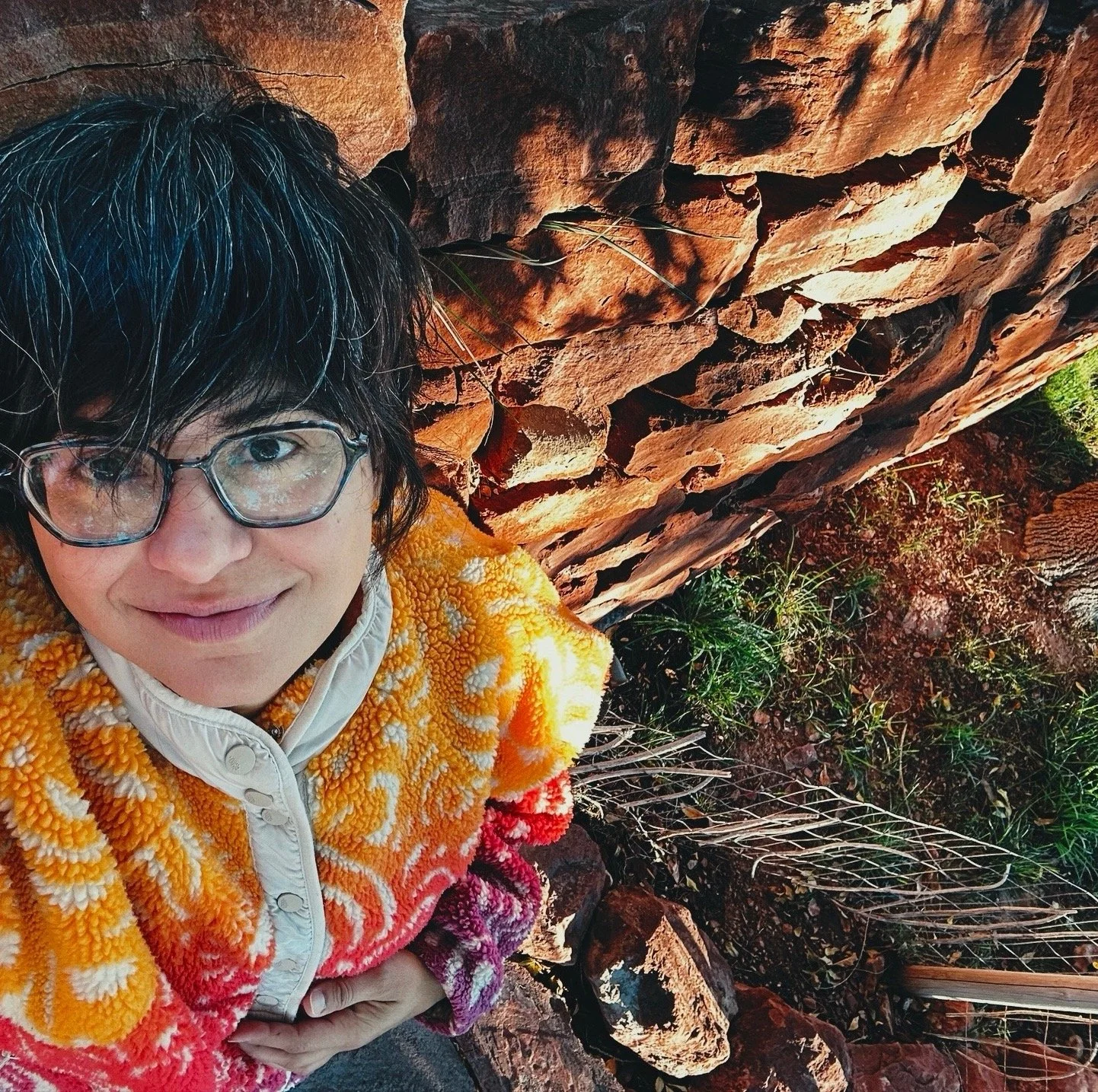 Patti Ibanez with glasses looking at camera with Sedona red rocks behind her
