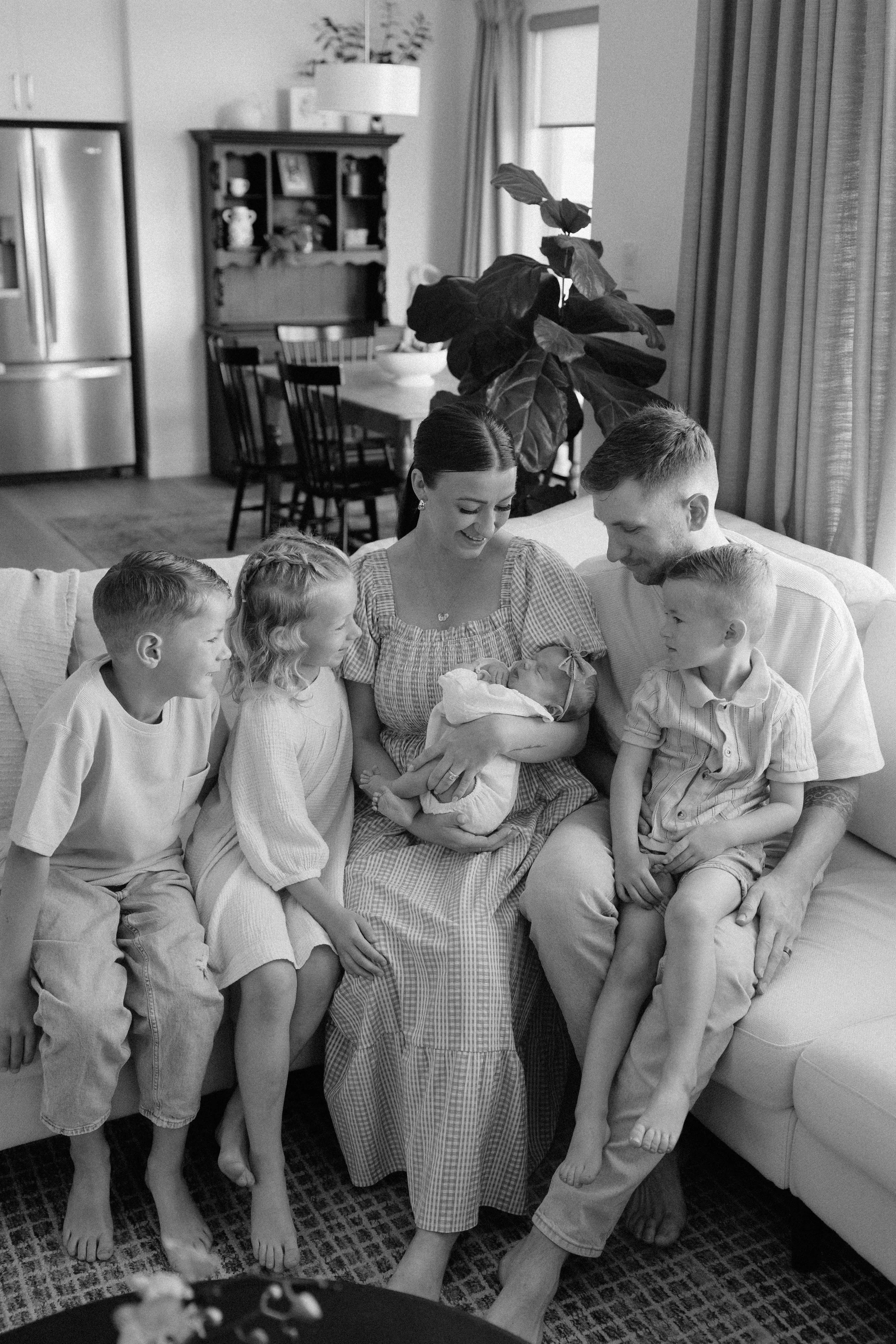 mother with her kids on her bed