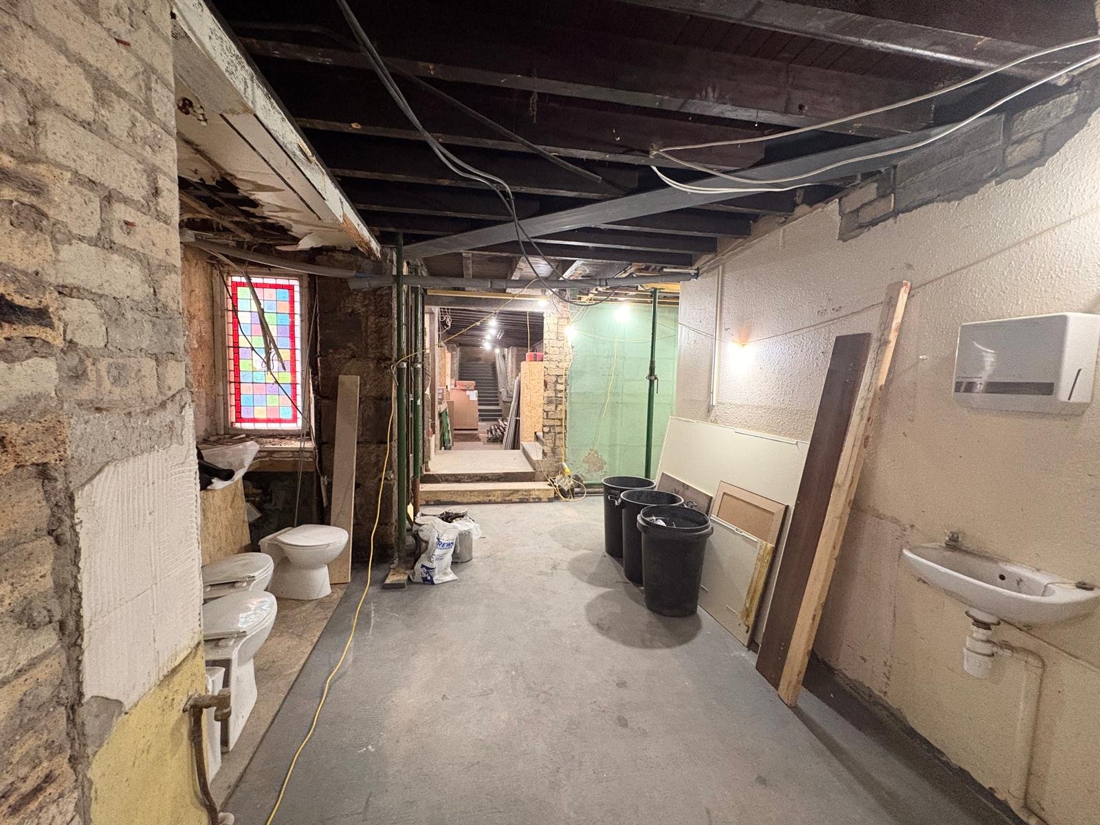 Behind the walls, essential infrastructure is taking shape. These bathrooms will help the building serve the many people who will gather here each week for programs, worship, and community events.