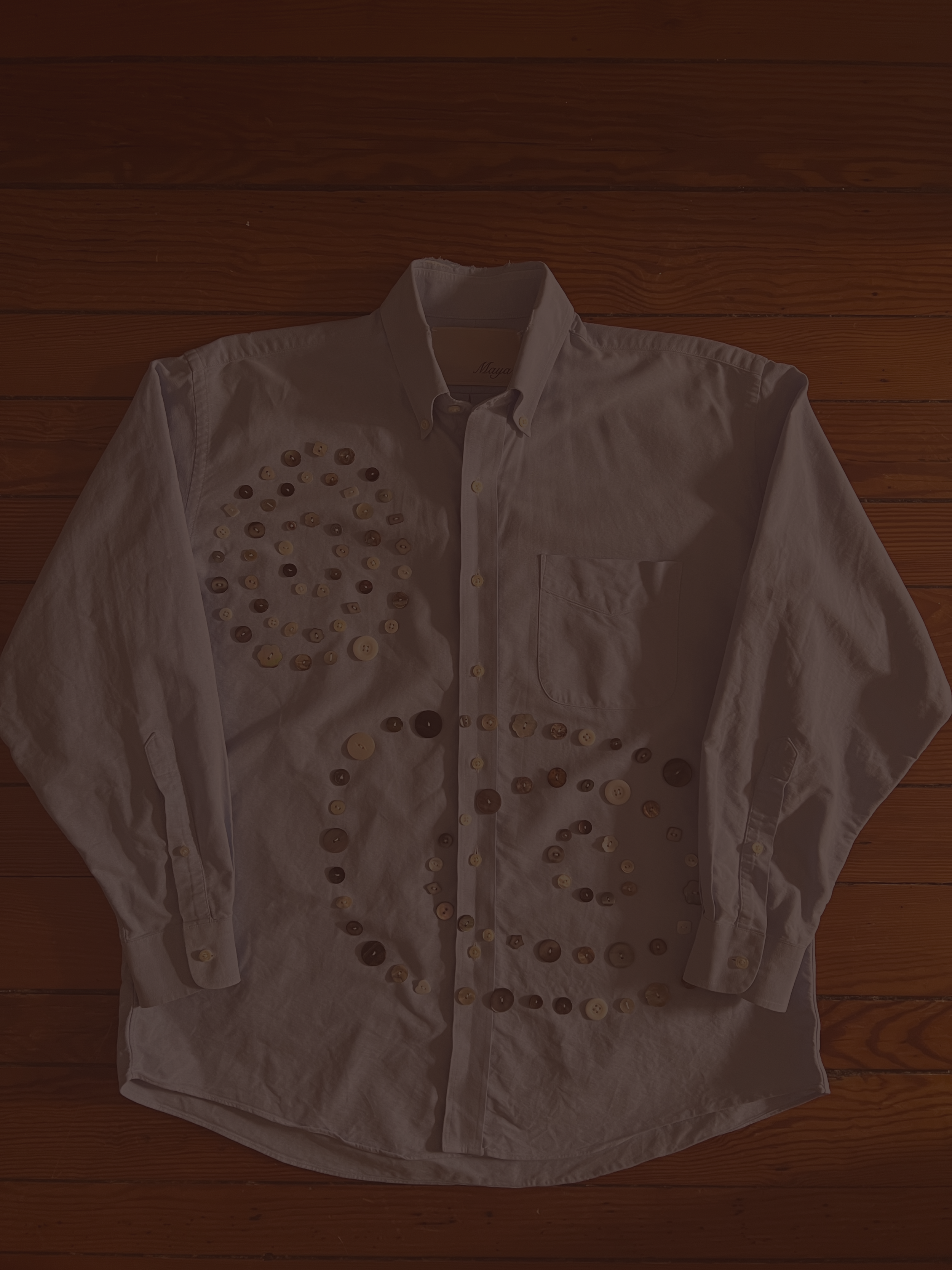 Button Shirt .38 | Size: 16-33 slim fit (men's L) | A thoughtfully sourced second-hand button-up featuring an assortment of hand-sewn buttons. Light blue. 
