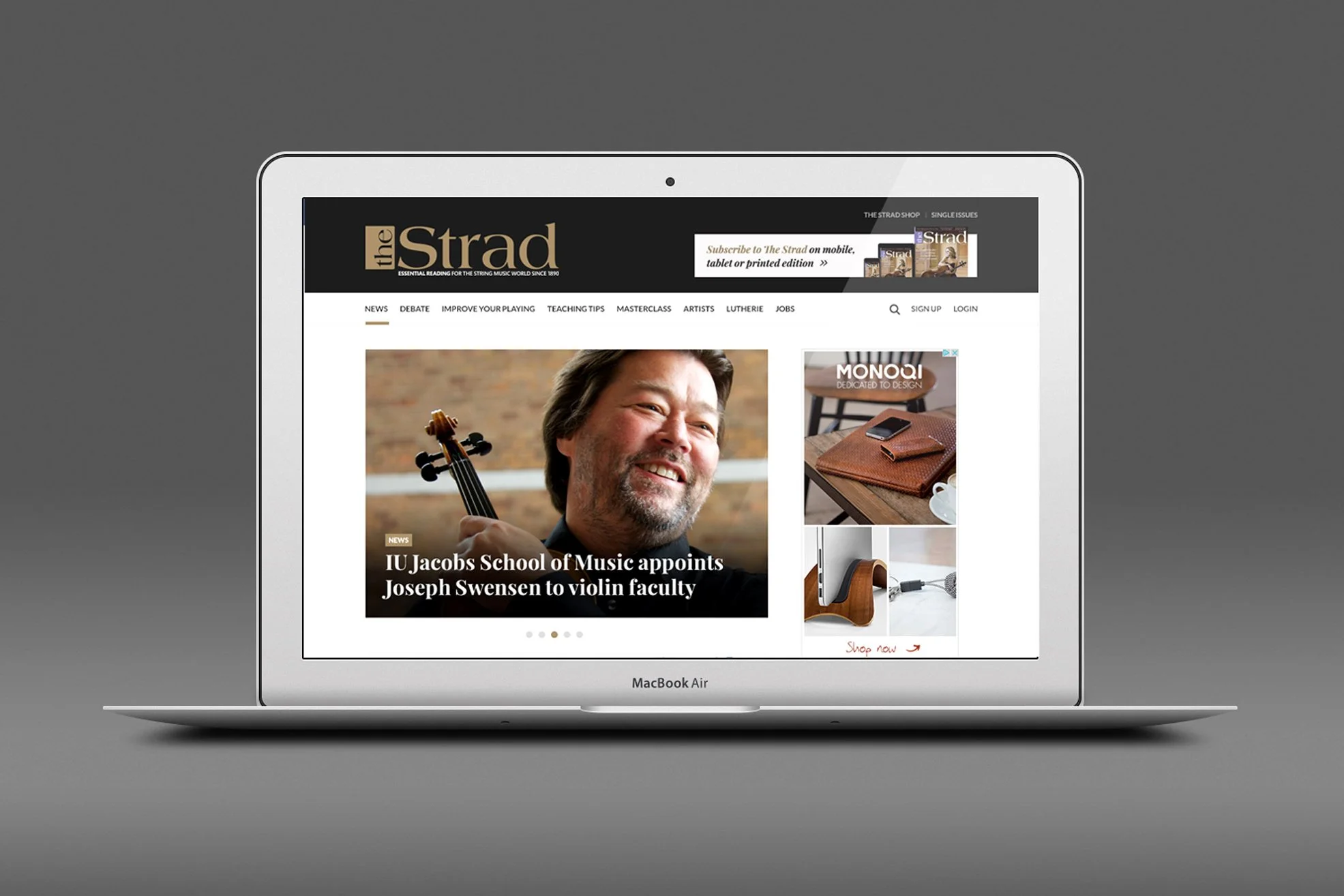 Laptop displaying "The Strad" magazine website featuring a violinist and news about Joseph Swensen joining the IU Jacobs School of Music.