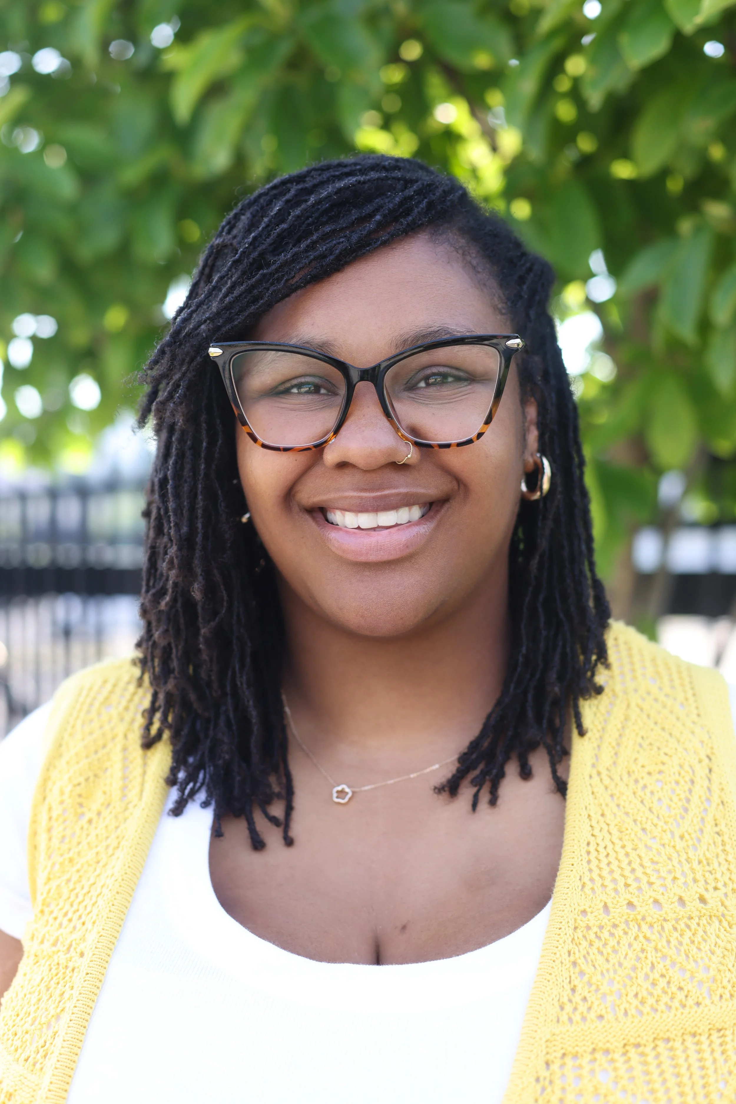 A Black therapist smiles at the camera. Teens deserve a space to process their feelings and build new skills. Get started with play therapy in St. Louis.