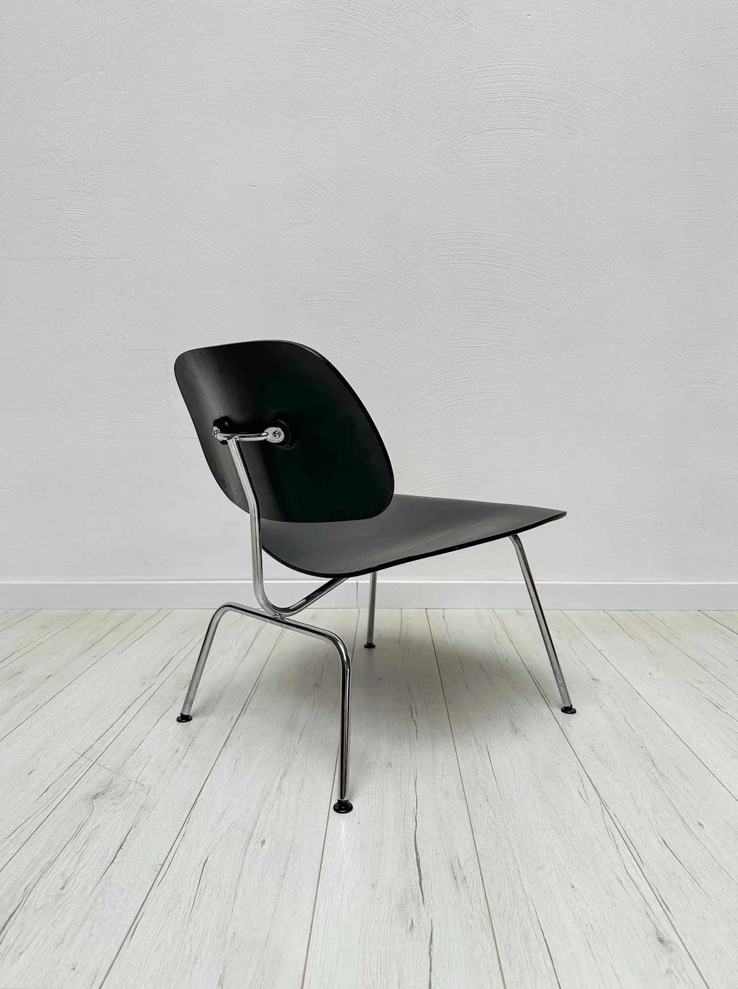 LCM Lounge Chair by Charles &amp; Ray Eames for Vitra, 1970s

Charles and Ray Eames developed their moulded plywood chairs in the 1940s &ndash; the LCM, with its low seat and metal base, is the relaxed lounge version.

Black ash plywood shells on a c
