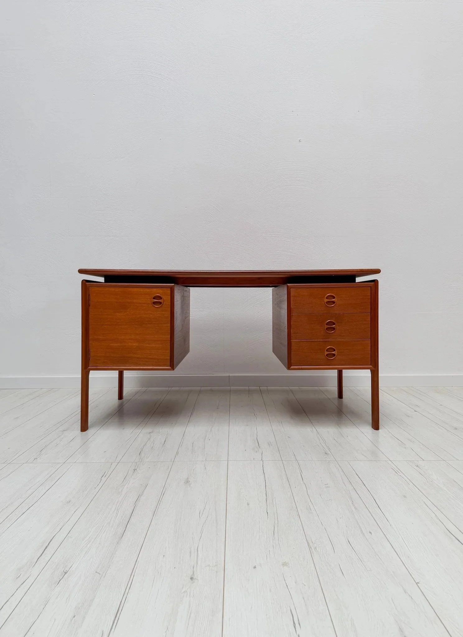 Teak Desk by G.V. Gasvig for G.V. M&oslash;bler, 1960s

A desk with an almost architectural lightness &ndash; finished with the sculpted handles typical of Danish design.

Three drawers and a cabinet in teak. The writing surface has been carefully re