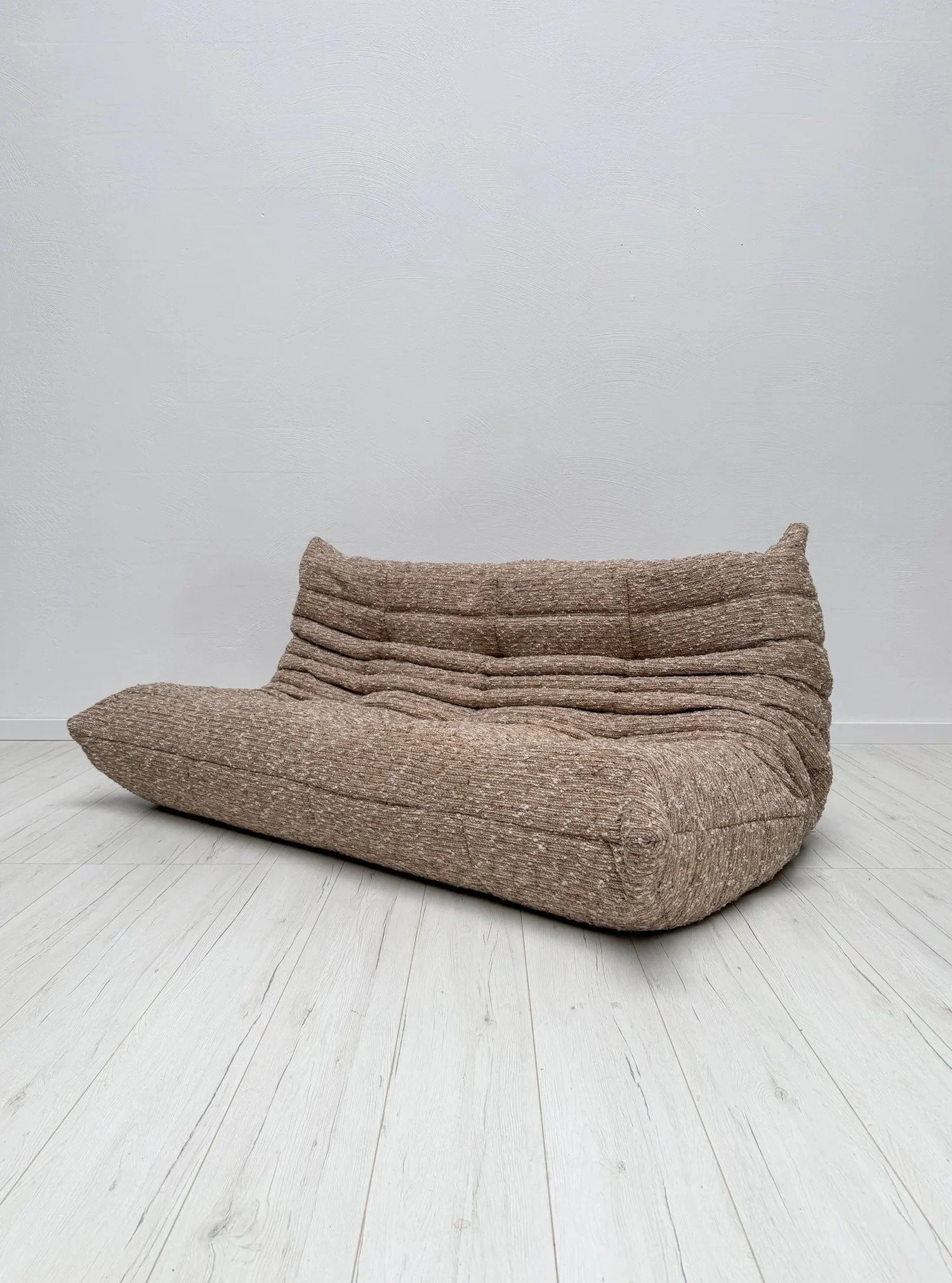 Togo 3-Seater by Michel Ducaroy for Ligne Roset

The Togo in a new coat: this 3-seater has been professionally reupholstered in a chunky, textured boucl&eacute;.

Cream, ivory, beige and taupe yarns on the timeless Togo shape. Excellent condition.

D