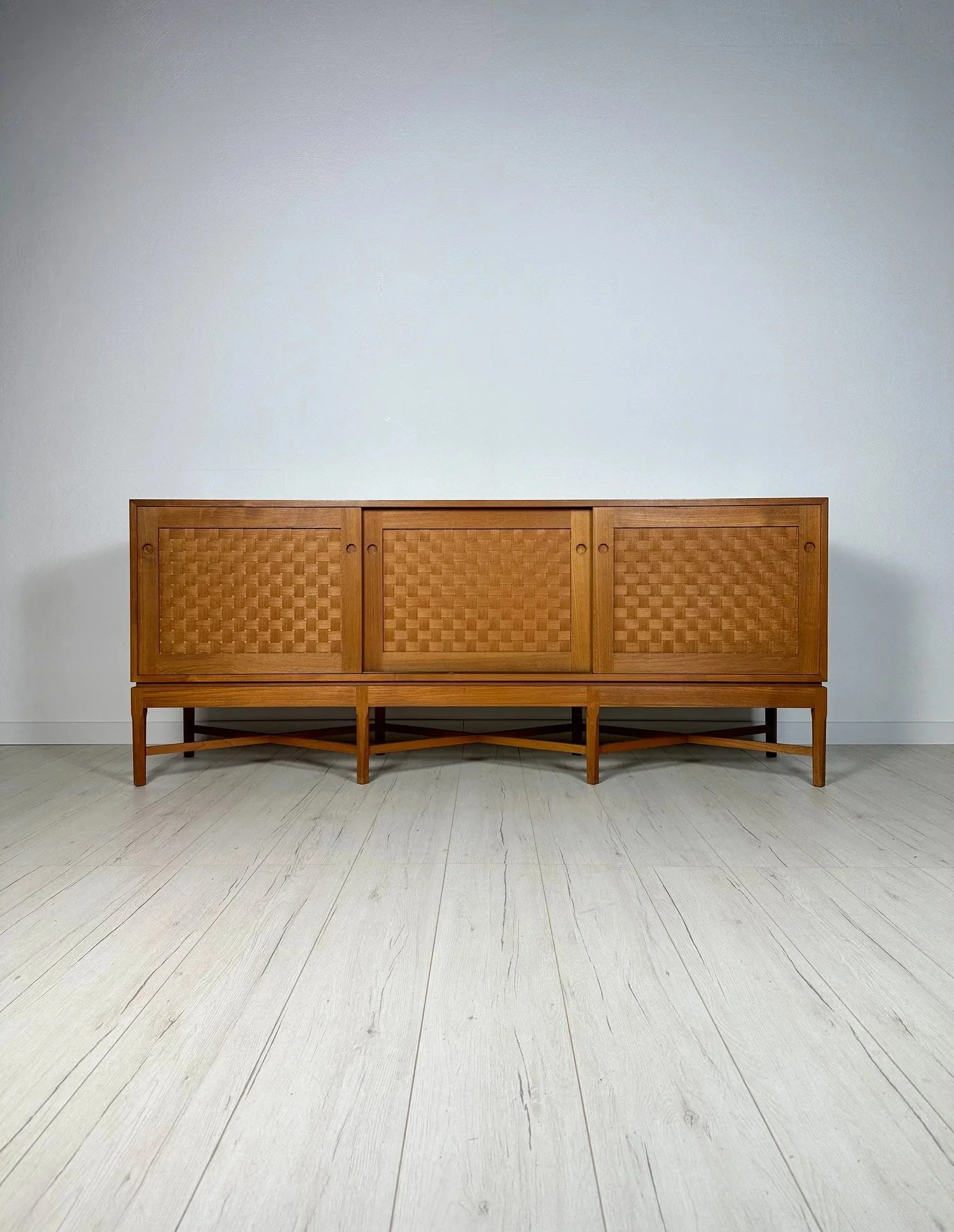 Rare Teak Sideboard by Ilse &amp; Ove Rix for Uldum M&oslash;belfabrik, early 1960s

A true rarity: the sliding doors of this sideboard are fronted with woven wood &ndash; a detail you will rarely see.

Clear lines and very high-quality workmanship i