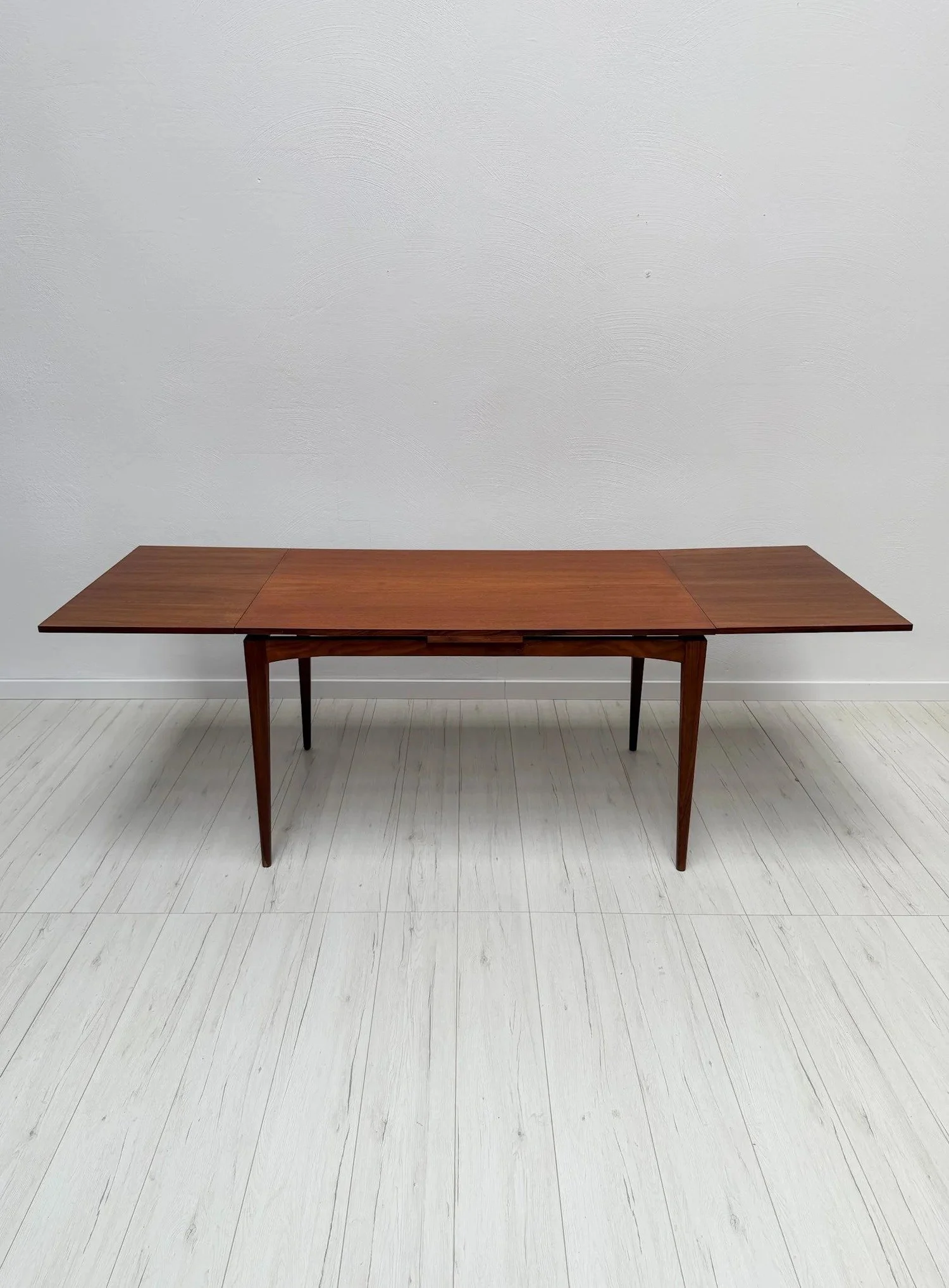 Scandinavian Teak Extendable Dining Table, 1960s

Everyday table for four, dinner table for eight &ndash; two extension leaves make it easy.

Clean rectangular top on slender tapered legs. The top has been carefully refinished.

Dimensions: W 125&nda