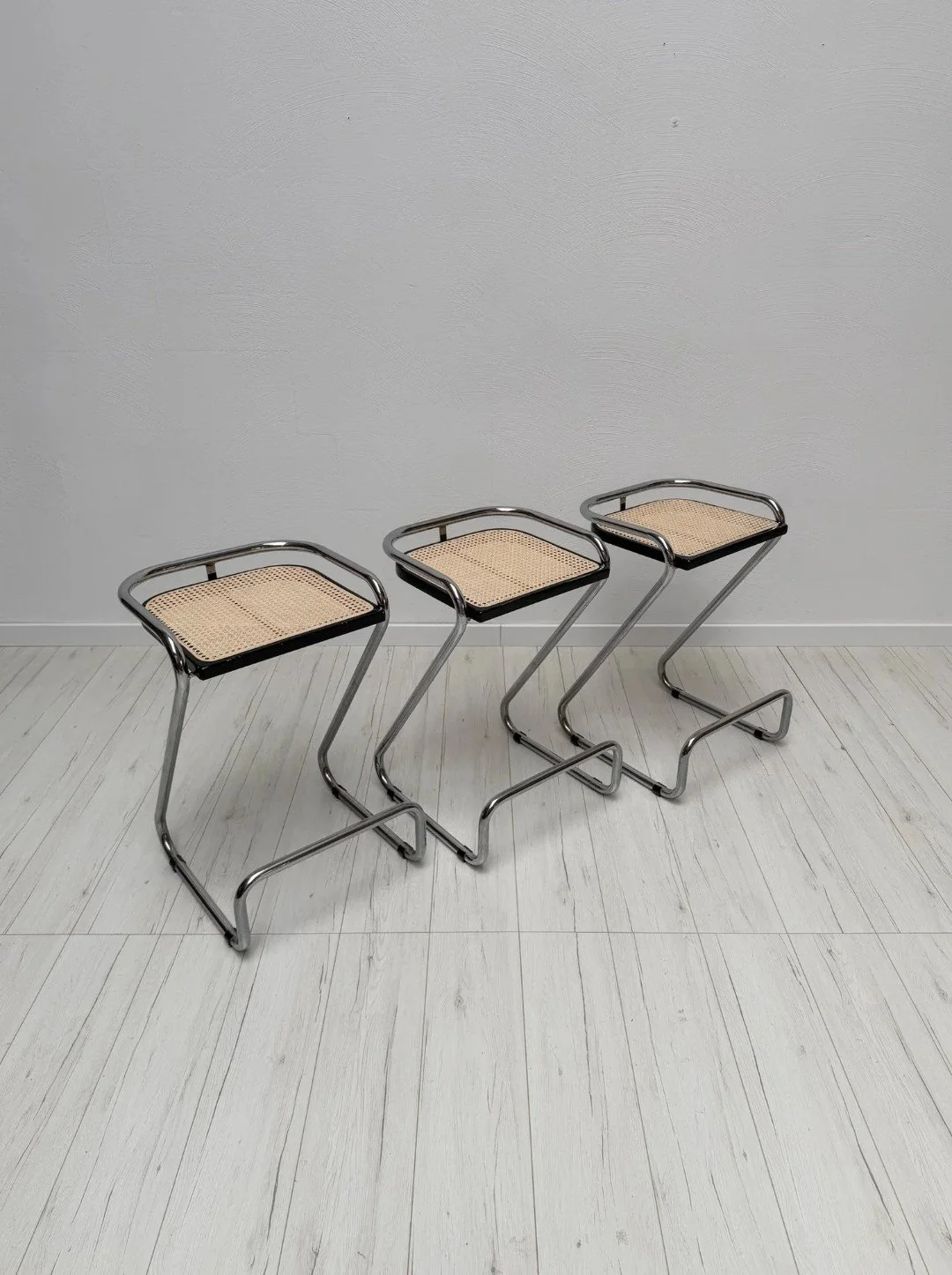 Set of 3 Wicker &amp; Chrome Barstools, Italy, 1970s

Cool chrome-plated frames meet warm, natural wicker &ndash; a minimalist Italian design reminiscent of Mariani and Charlotte Perriand. The wicker seats have been professionally replaced; the frame