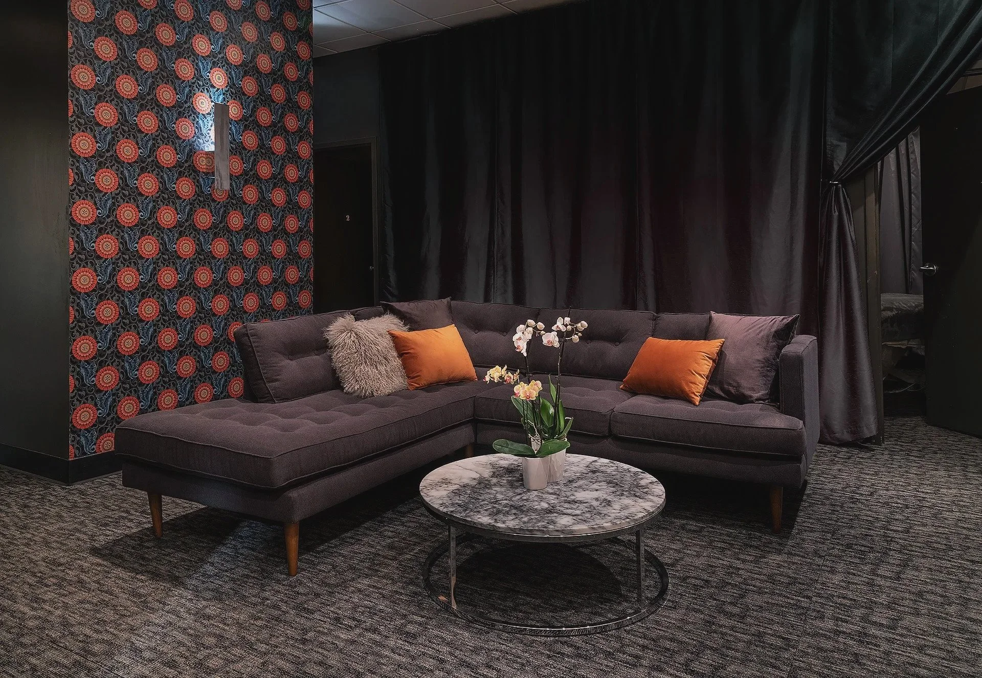 The tranquil spa guest lounge at bijin salon & spa in Kansas City, designed for cozy relaxation with luxury seating and modern decor.