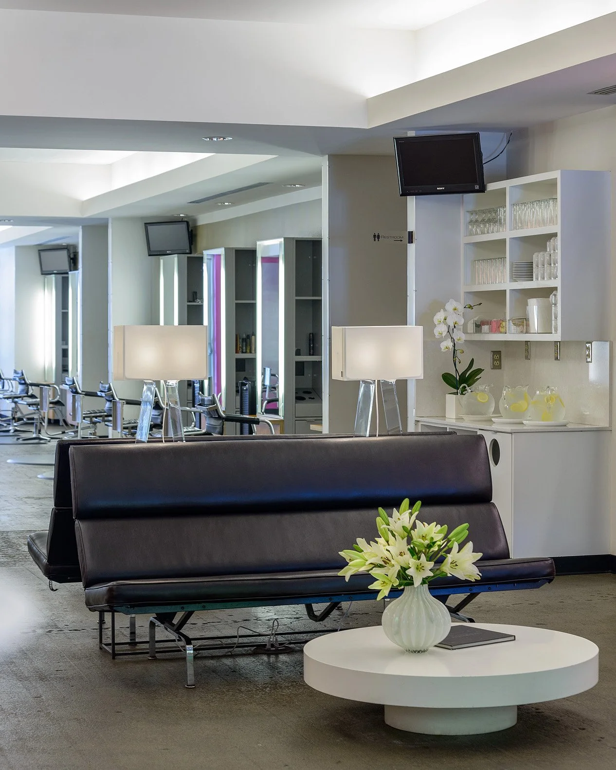 Relax in our modern guest lounge, enjoy a complimentary beverage, and explore our premium retail offerings at bijin salon & spa in Prairie Village.