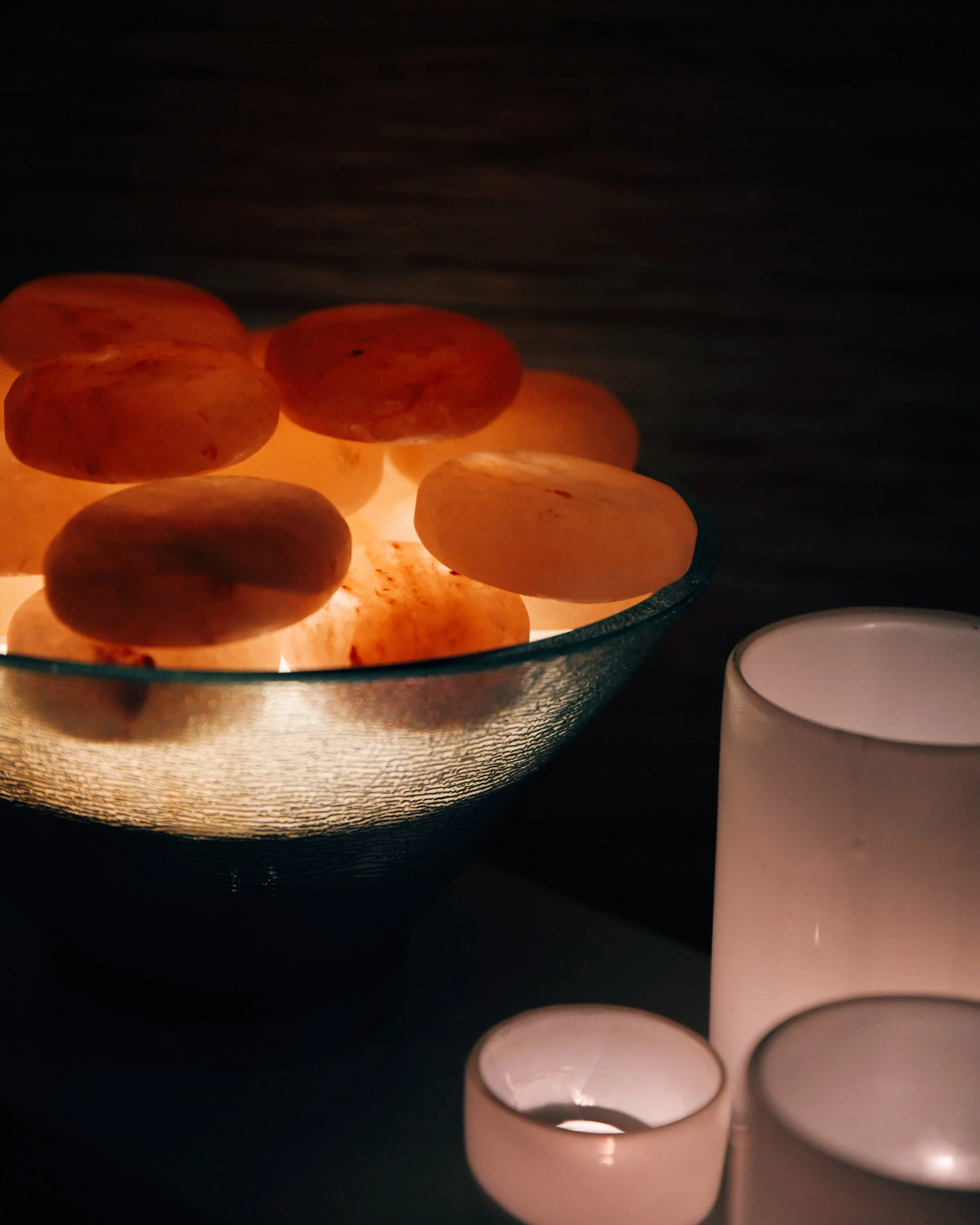 Hand carved Himalayan salt stones prepared for a hot stone massage in a spa treatment room at bijin in Prairie Village.