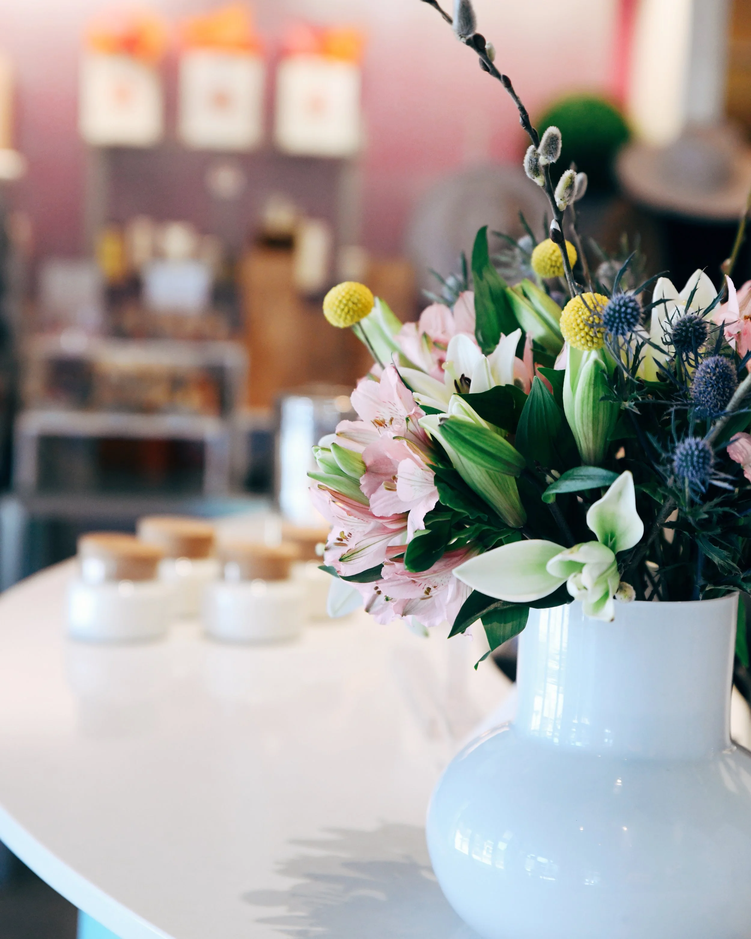 Fresh flowers decorate the concierge desk overlooking the retail boutique at bijin salon & spa in The Prairie Village Shops.