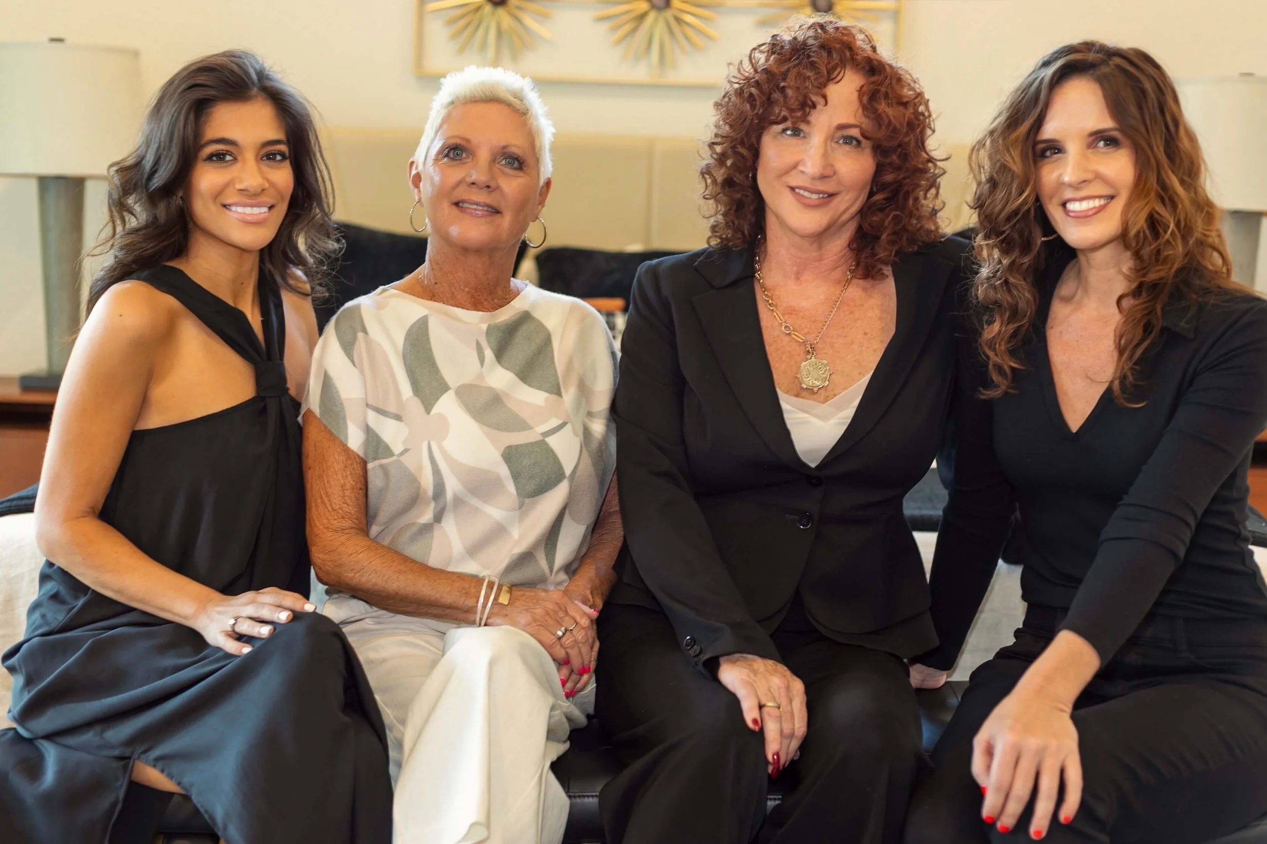 Khrome Interiors team with Angela sitting on a bench together