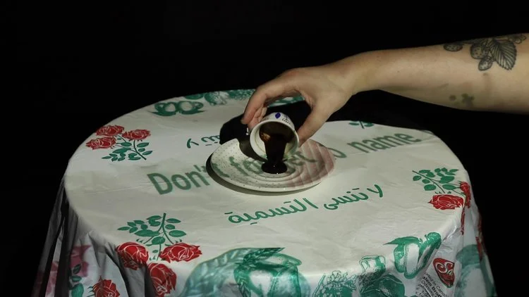 A phone conversation sets the diasporic table as a disembodied figure prepares Qahwah Arabi / Arabic Coffee. Here, the contradictions inherent in Google Translate’s instant camera feature are made visible through glitched mistranslations. Using these