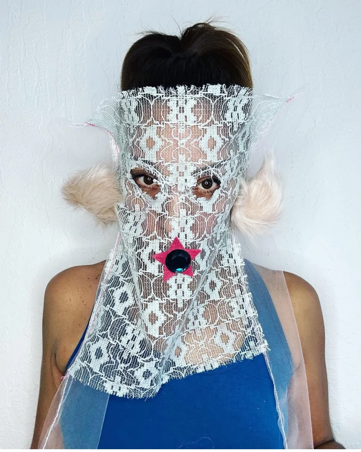 Baby blue lace mask with magenta star, blue jewel, white fur puffs, and pink tulle