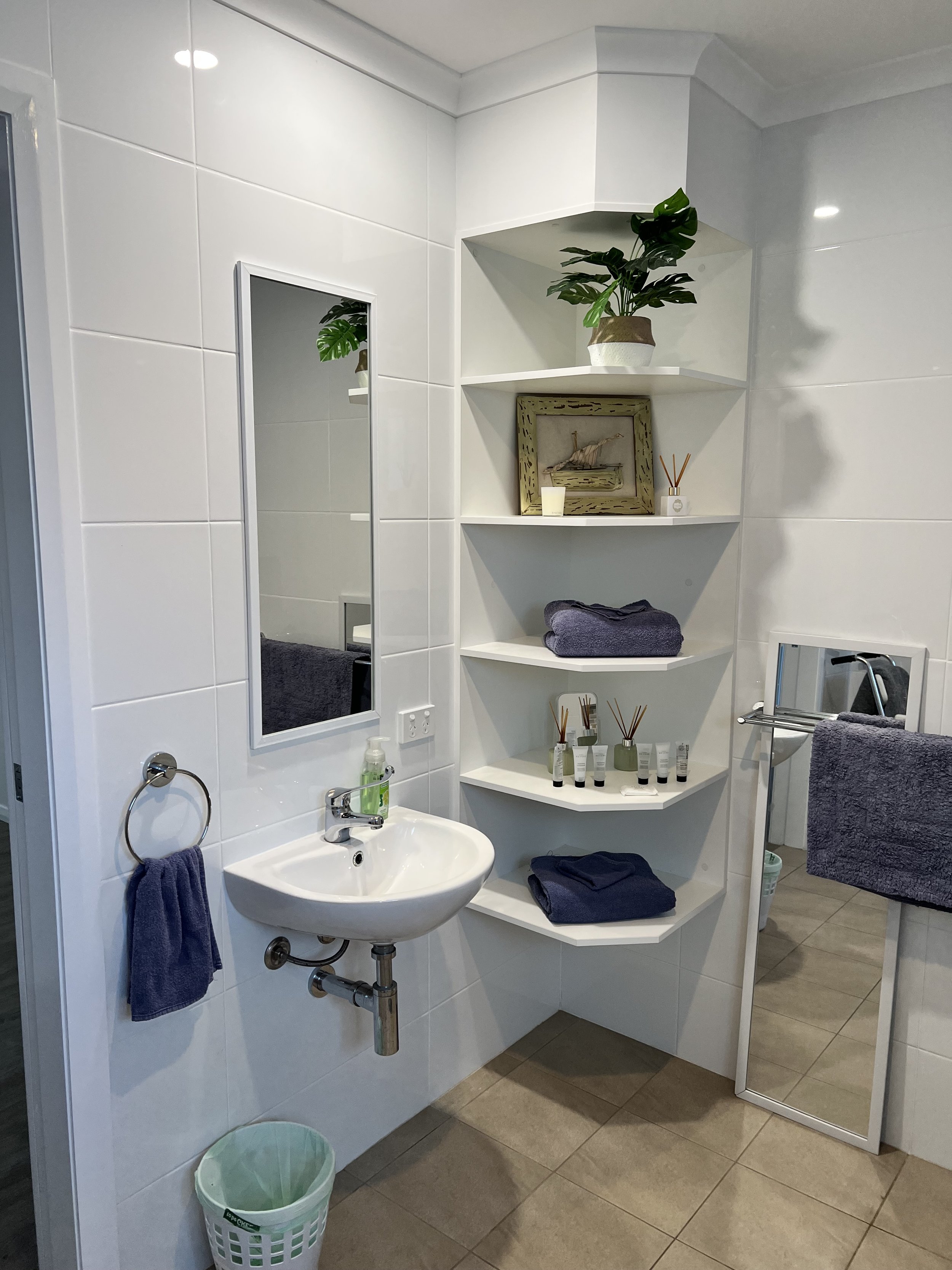 Modern bathroom with roll-under sink and shelving