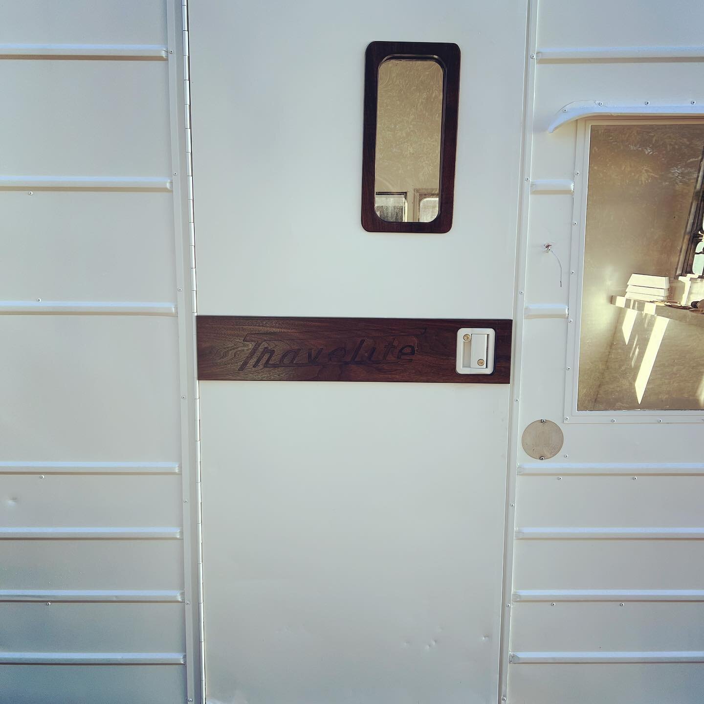 The &ldquo;Blank Slate&rdquo; got some new door details today.  Round corner windows, outside banners and teardrop detail inside all made from solid #walnut and finished with marine varnish for weather durability. Travelite logo carved in the banner 