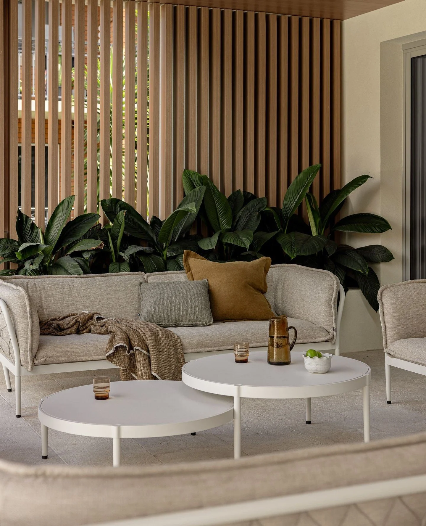 Lush greenery, soft privacy shutters and a warm, neutral palette come together to create a space that feels both protected and open. A quiet outdoor retreat designed for slowing down. A place to linger, morning to evening. ⁠