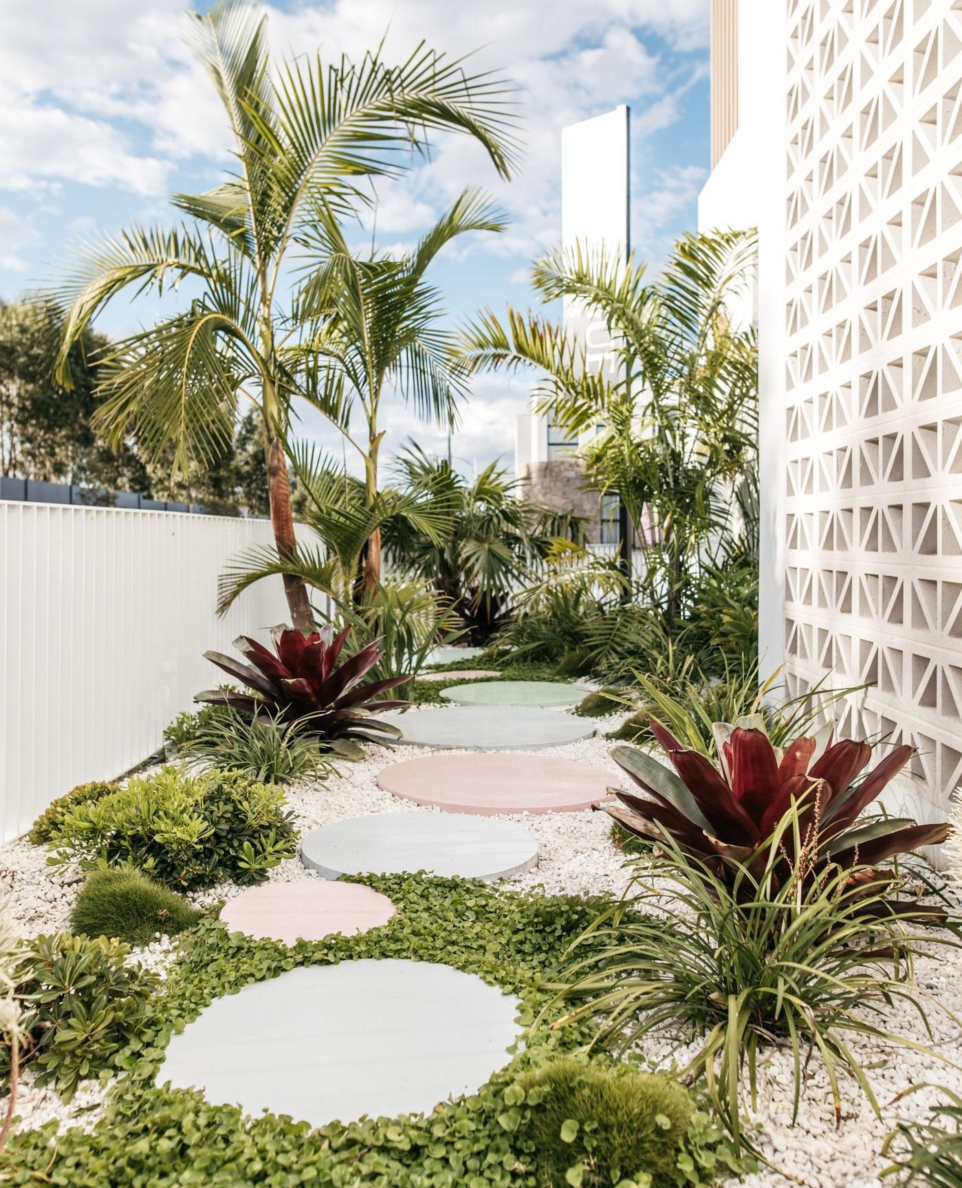 A playful pathway brought to life with splashes of colour and lush, foliage-focused planting. This transition space blurs the line between garden and pathway, transforming the side of a corner block into an experience of discovery.