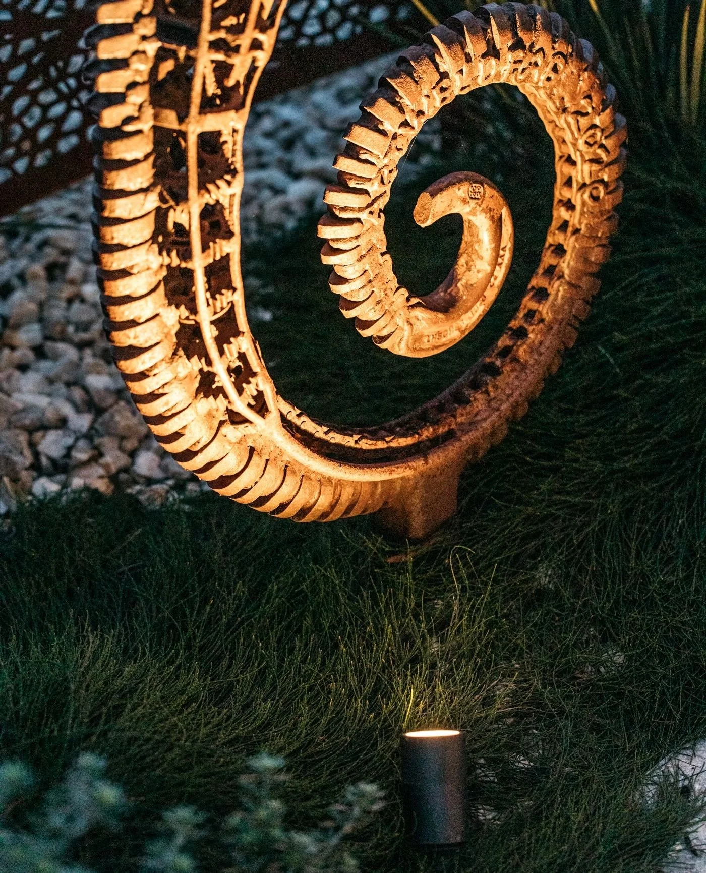 Soft garden lighting brings this unique sculpture to life. Highlighting its intricate form and material finish, it becomes a striking focal point that transforms the garden after dark.