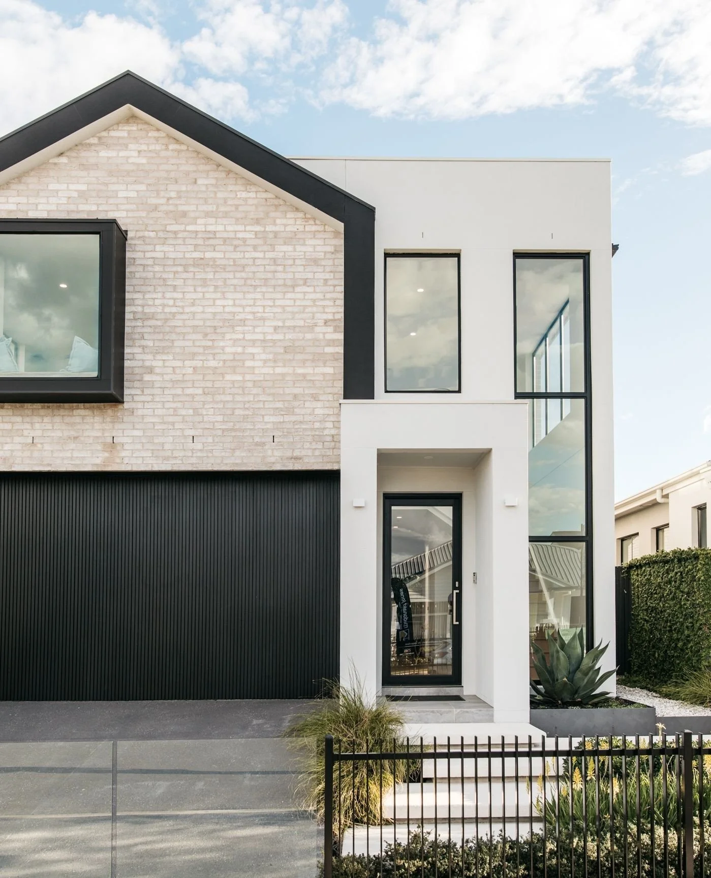 This design focuses on creating balance, where structured forms meet mass foliage planting. The textured brickwork and crisp white render are complemented by low, textural greenery, adding depth without overwhelming the facade. Carefully selected pla