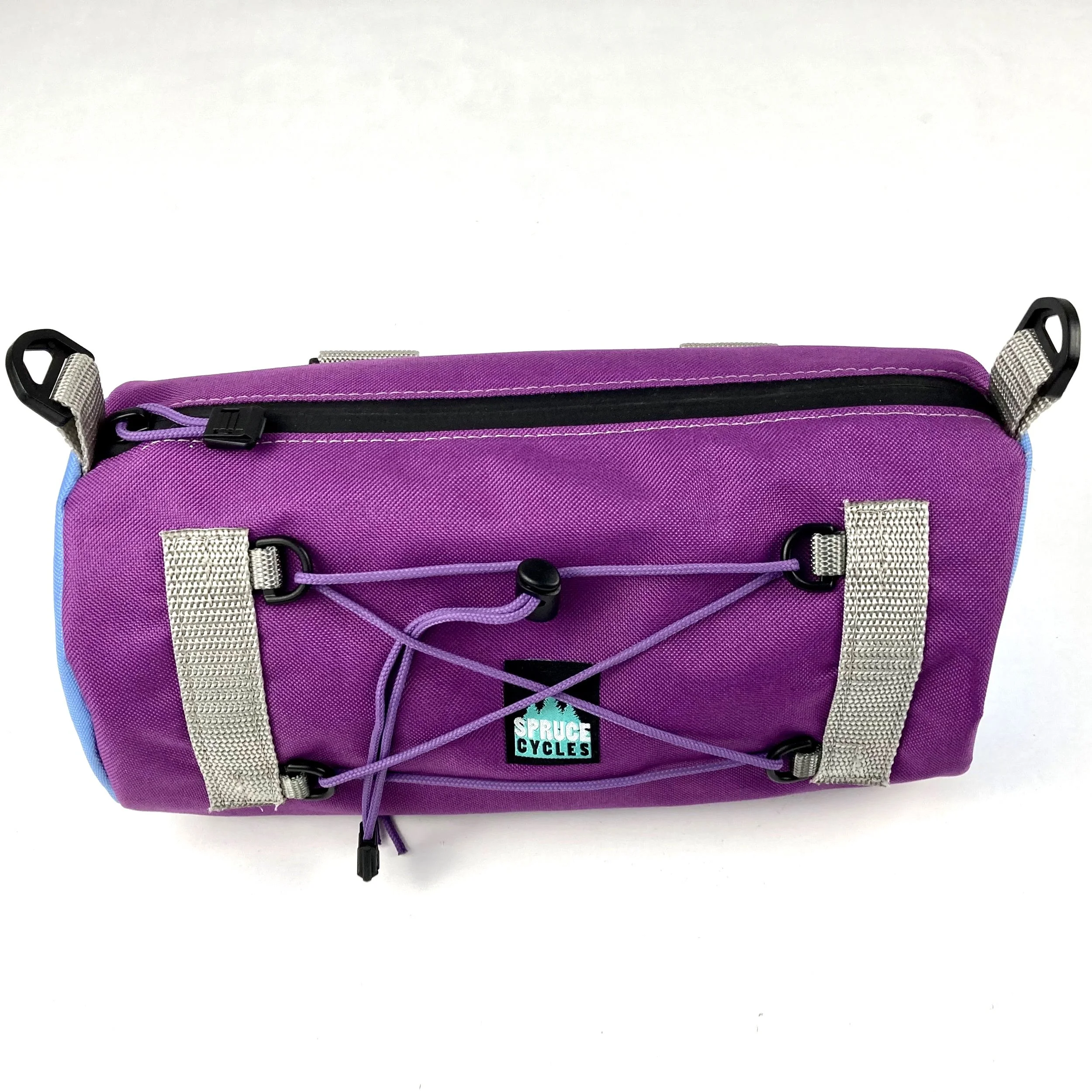Purple Spruce Cycles waist bag with gray straps, black zipper, and a front bungee cord with a toggle