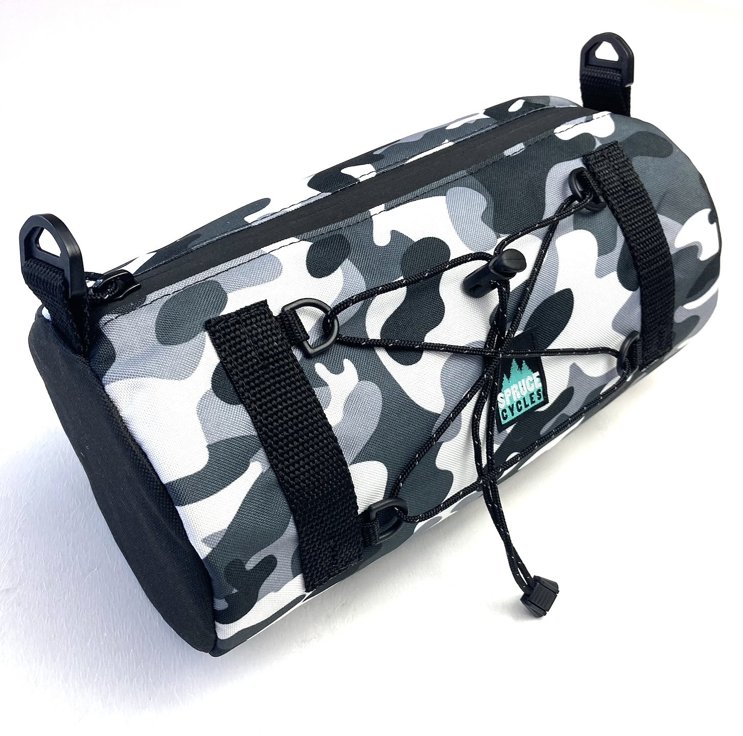 Camouflage-patterned bicycle saddle bag with black straps and a bungee cord with a toggle